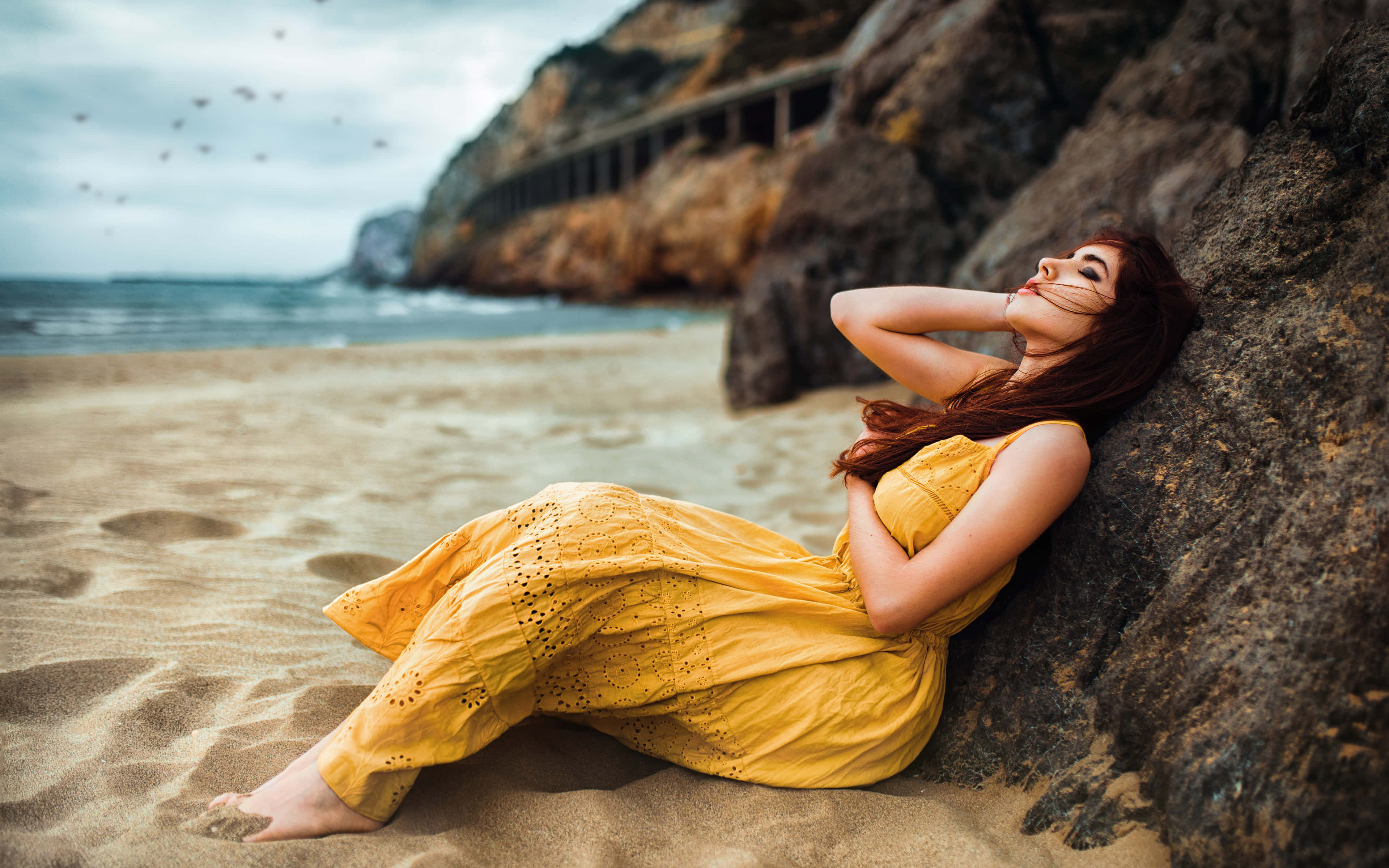 yellow dress, sandy beach, large rock, 4K Desktop Wallpaper
