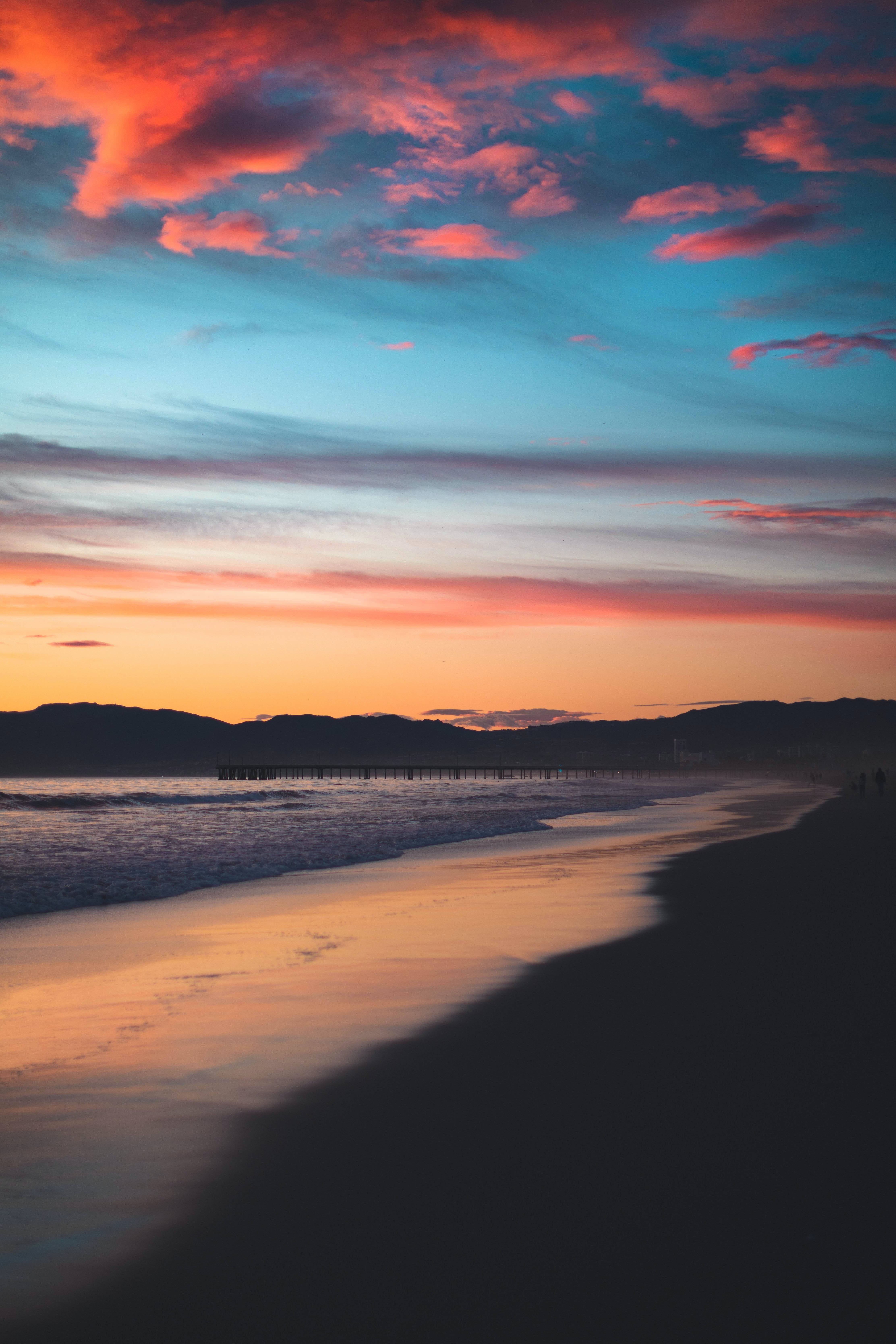 red and blue beach sunset, vibrant sunset, fiery orange and pink hues, 5K Phone Wallpaper
