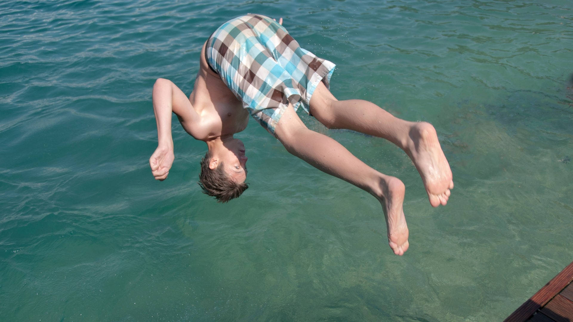 summer season tumbling dive, plaid shorts, clear turquoise water, Full HD Desktop Wallpaper