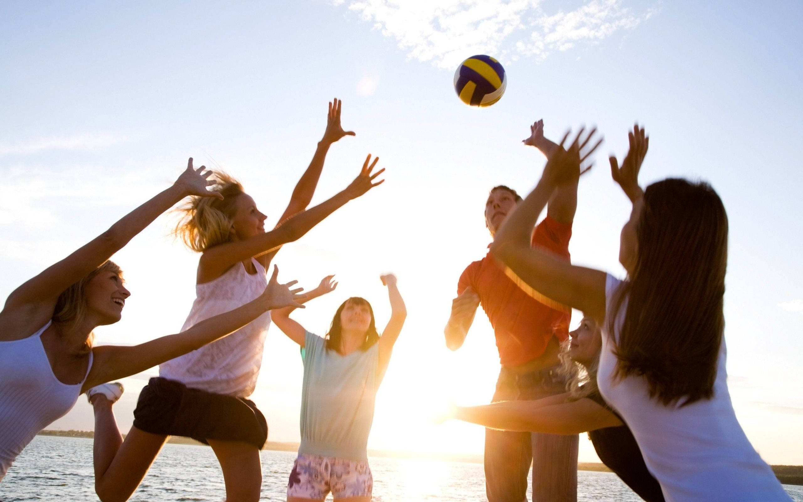 beach volleyball, glowing sunset, water, 2K Desktop Wallpaper