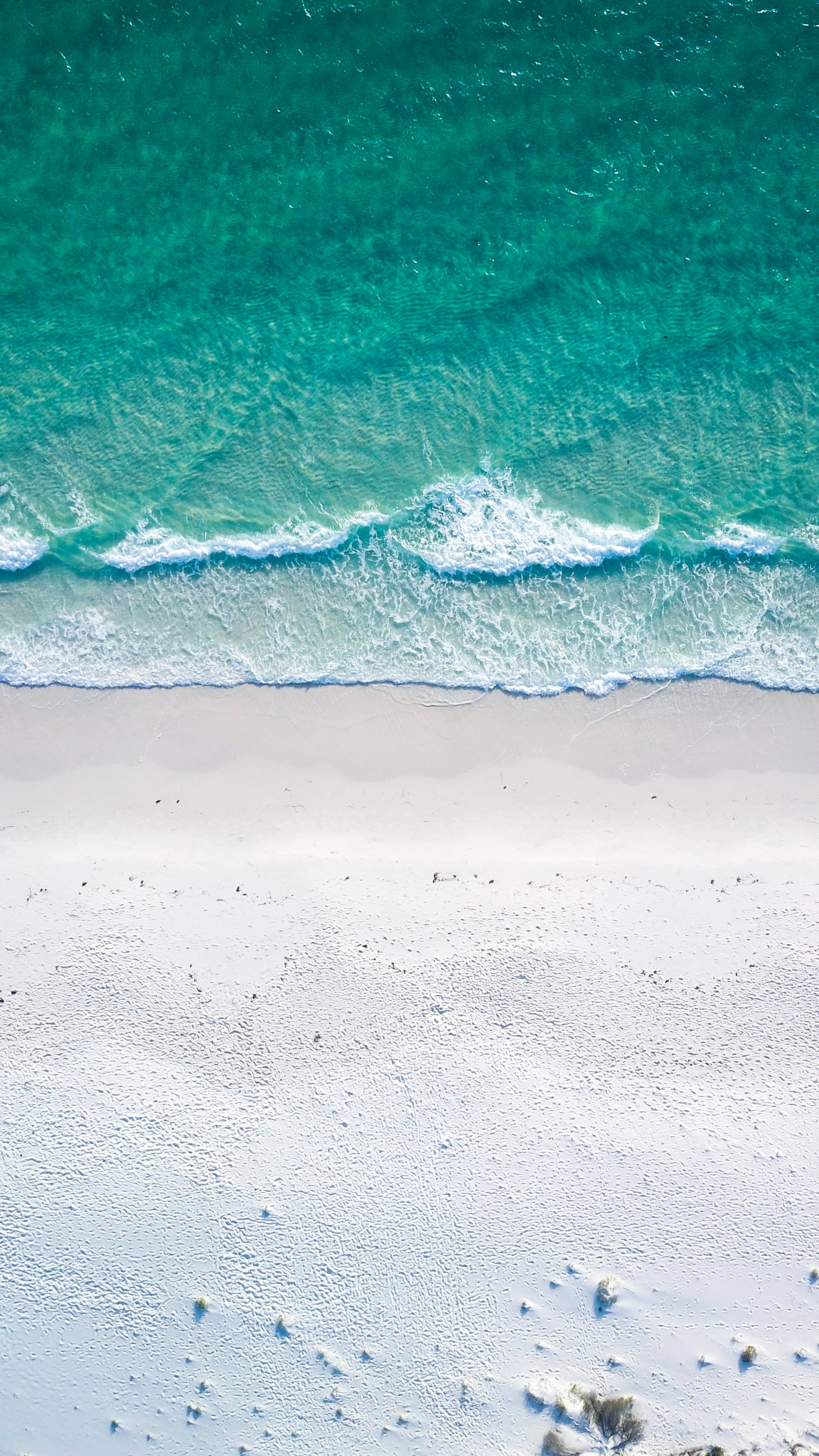 turquoise ocean waves, pristine white sandy beach, aerial view, 2K Phone Wallpaper