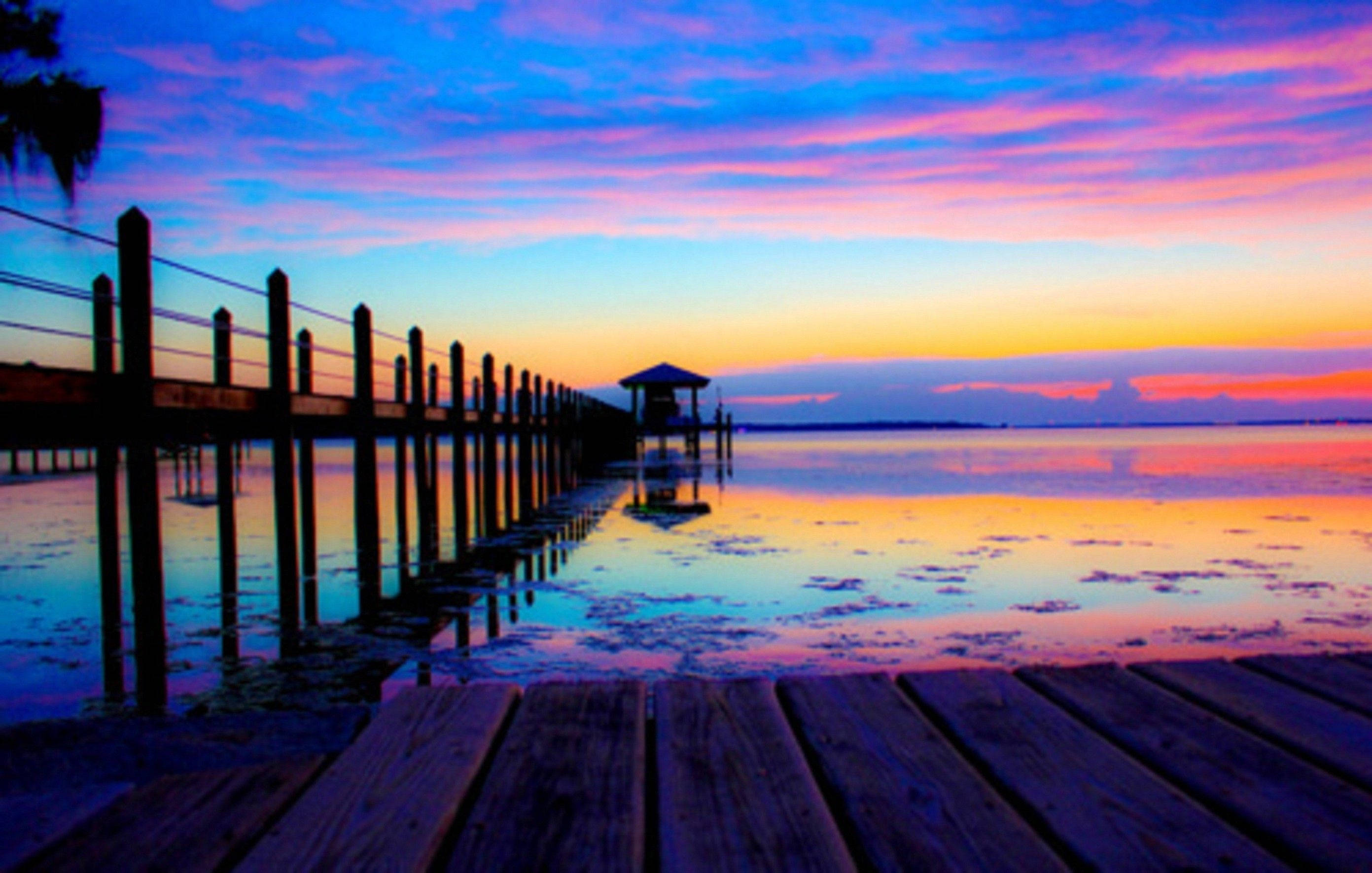 wooden pier, calm water, vibrant sunset sky, 2K Desktop Wallpaper