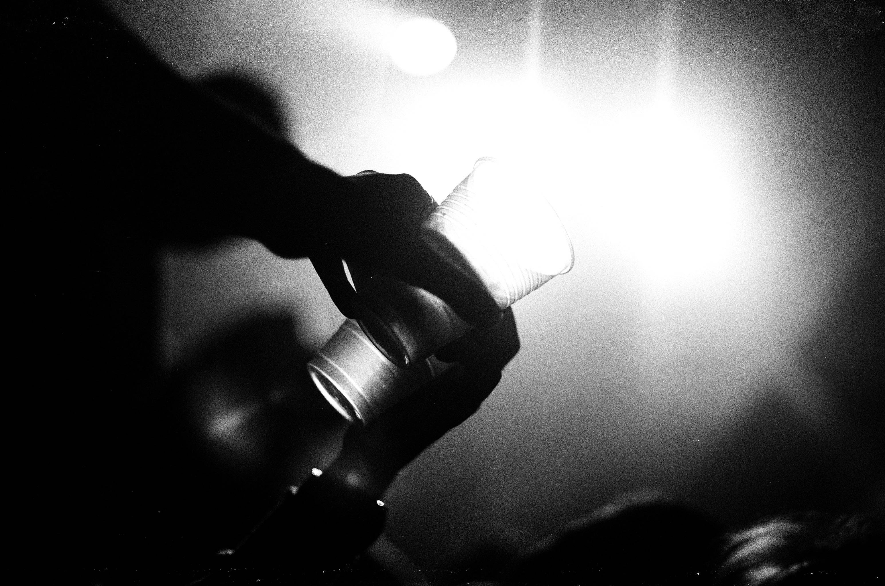 Beaker, glowing lightbulb, silhouetted hand, 2K Desktop Wallpaper