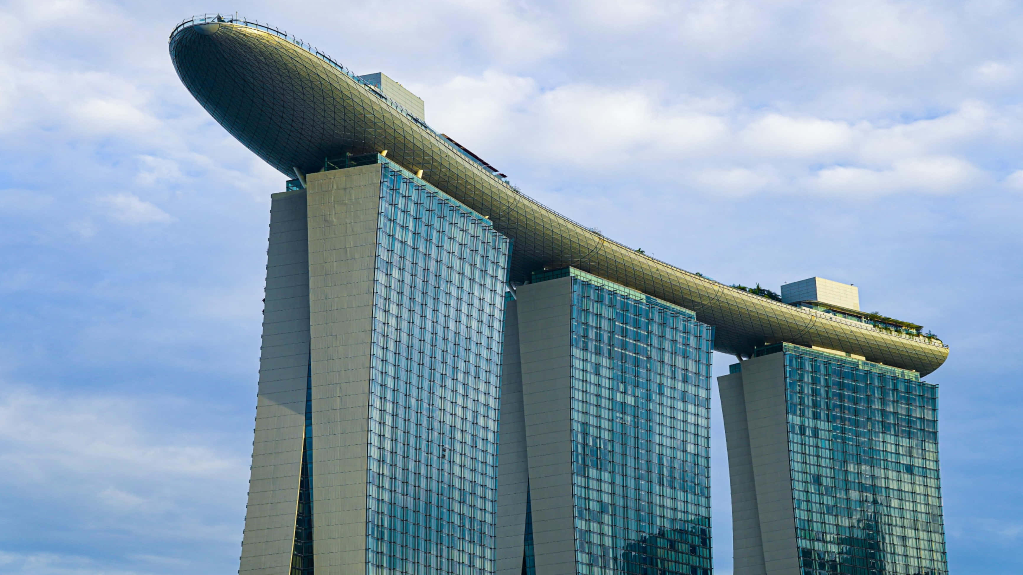 glass skyscrapers, massive sky bridge, partly cloudy blue sky, 2K Desktop Wallpaper