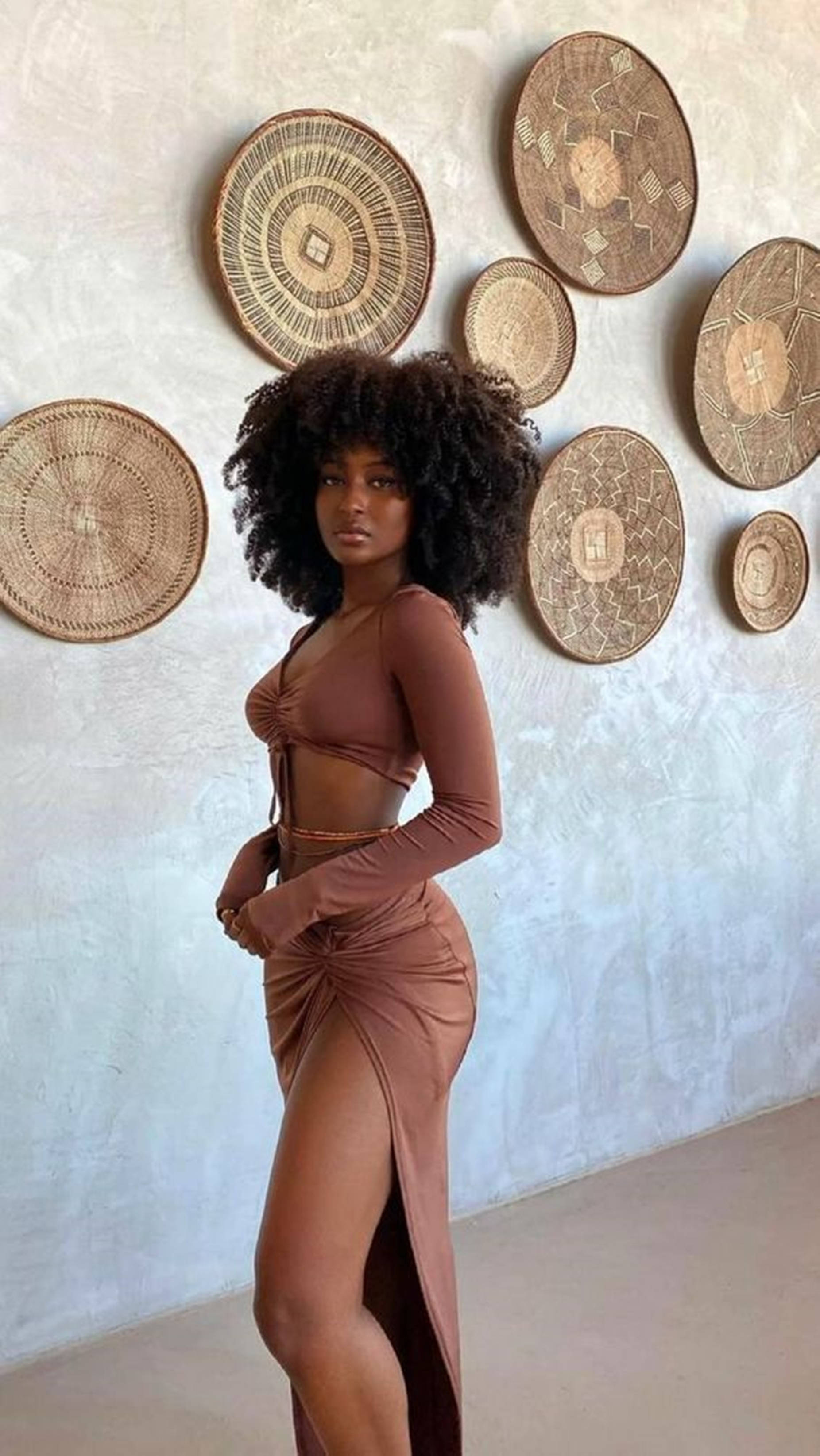 voluminous curly hair, brown crop top, high slit skirt, 2K Phone Wallpaper