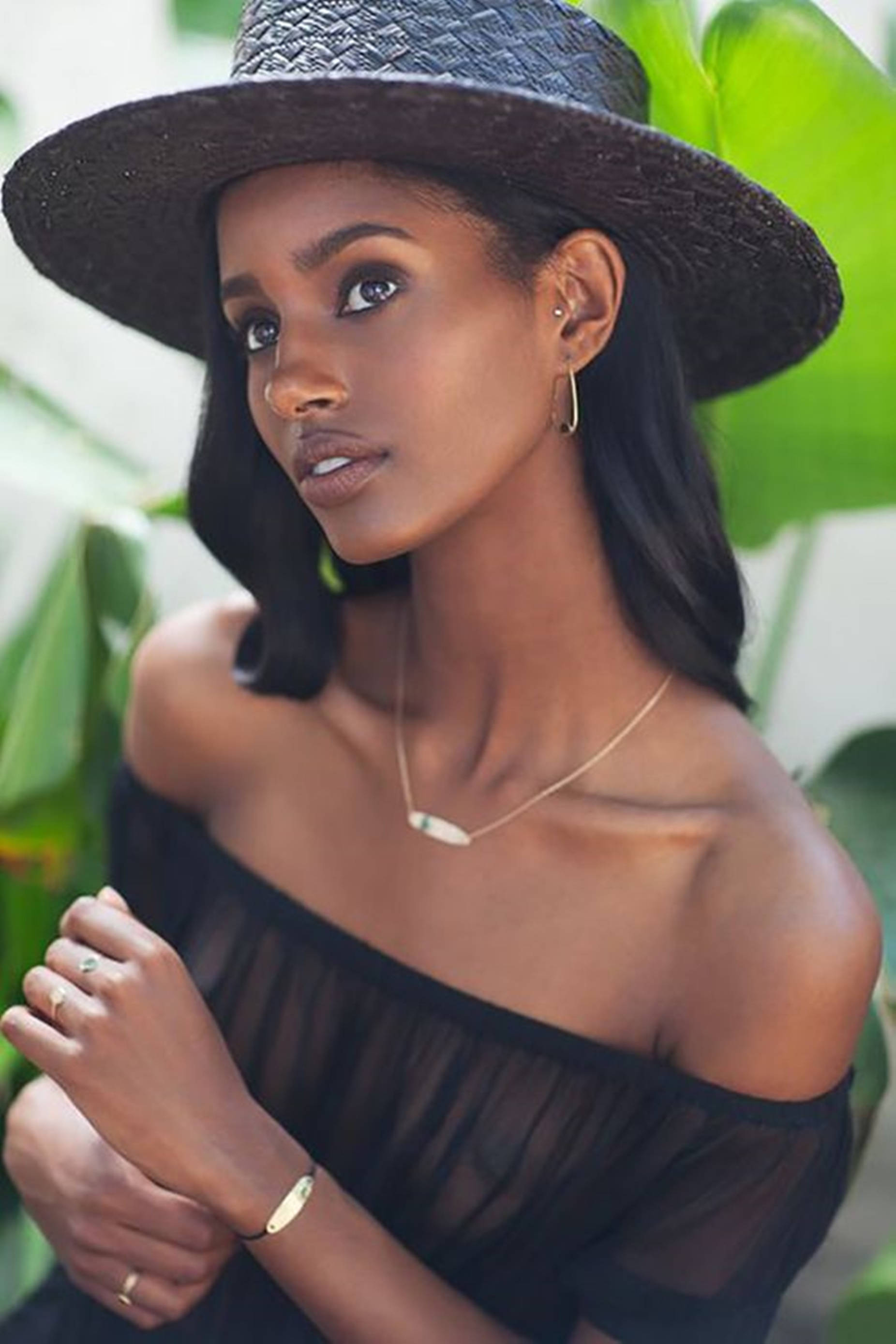 bohemian aesthetic, wide-brimmed hat, lush green foliage, 2K Phone Wallpaper