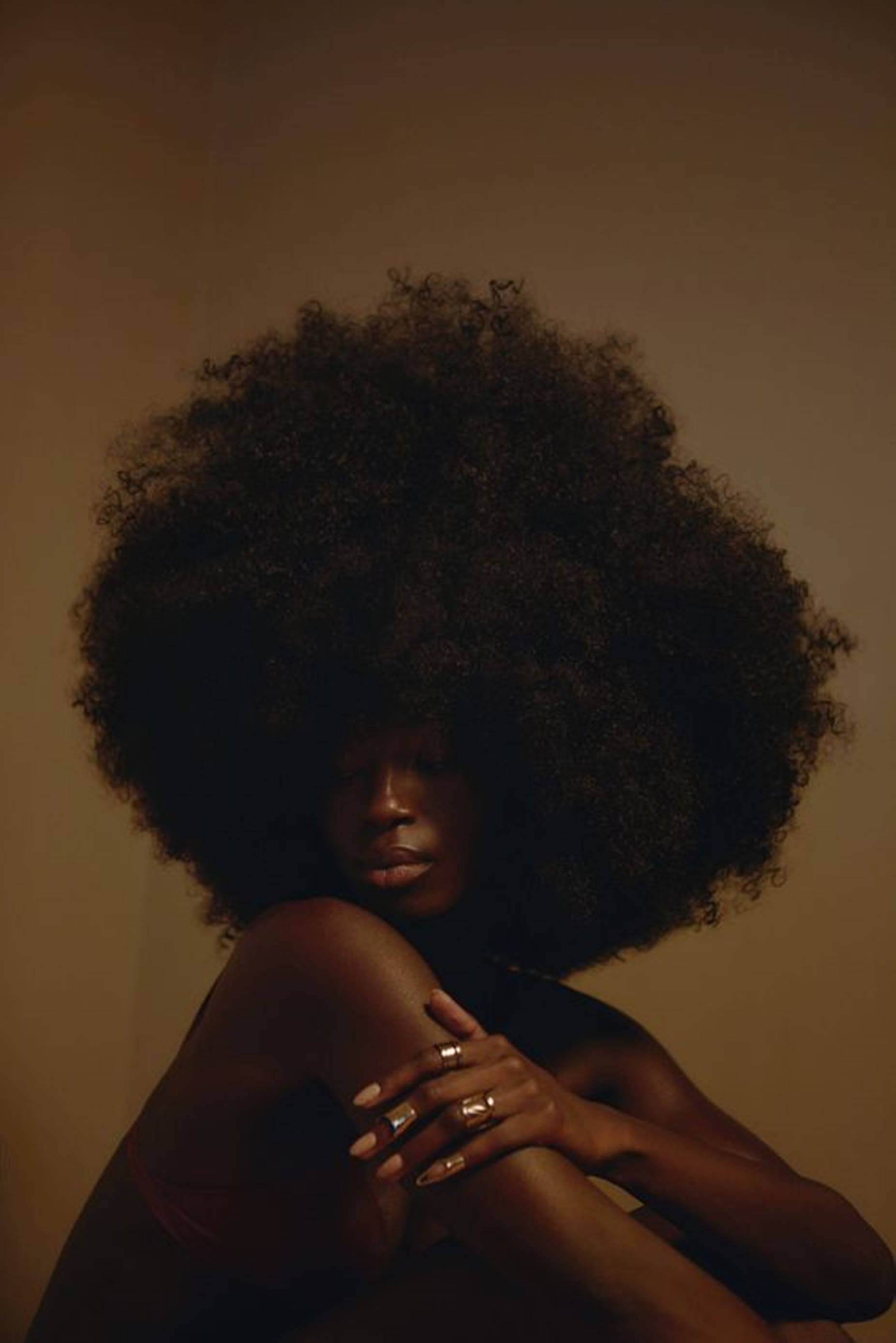 beautiful black woman, voluminous afro, warm golden light, 2K Phone Wallpaper