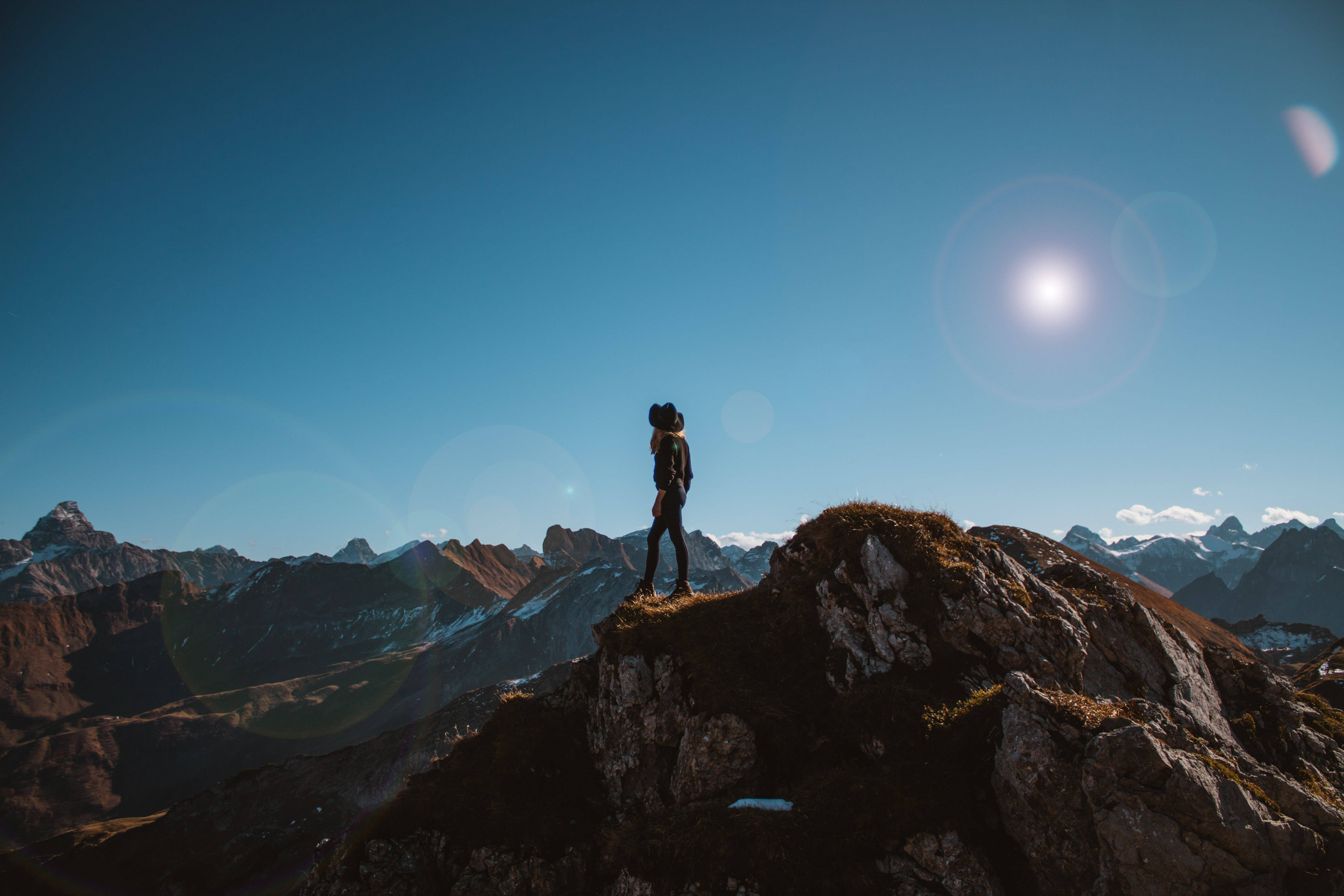woman, rugged mountain peak, clear blue sky, 4K Desktop Wallpaper