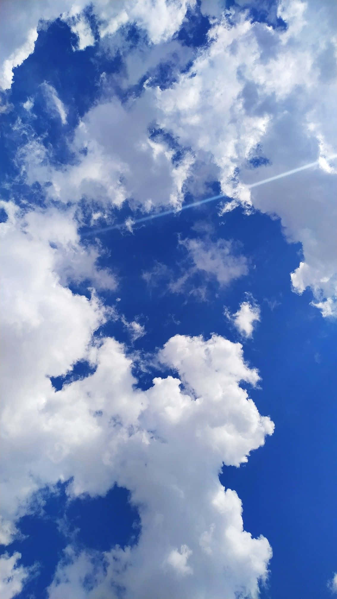 Vibrant blue sky, fluffy white clouds, bright sunbeam, Full HD Phone Wallpaper