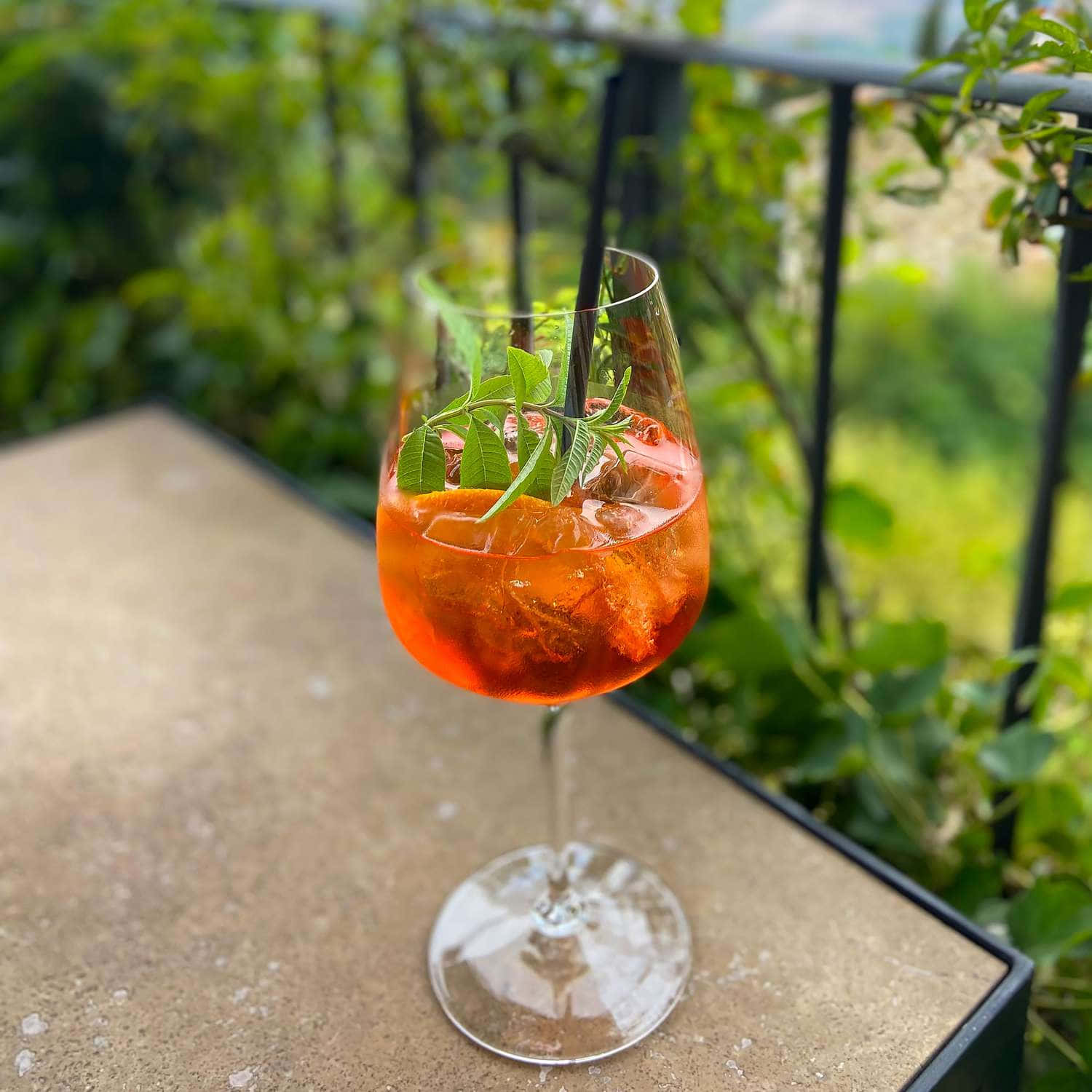 vibrant orange cocktail, stemmed glass, stone patio table, HD Desktop Wallpaper