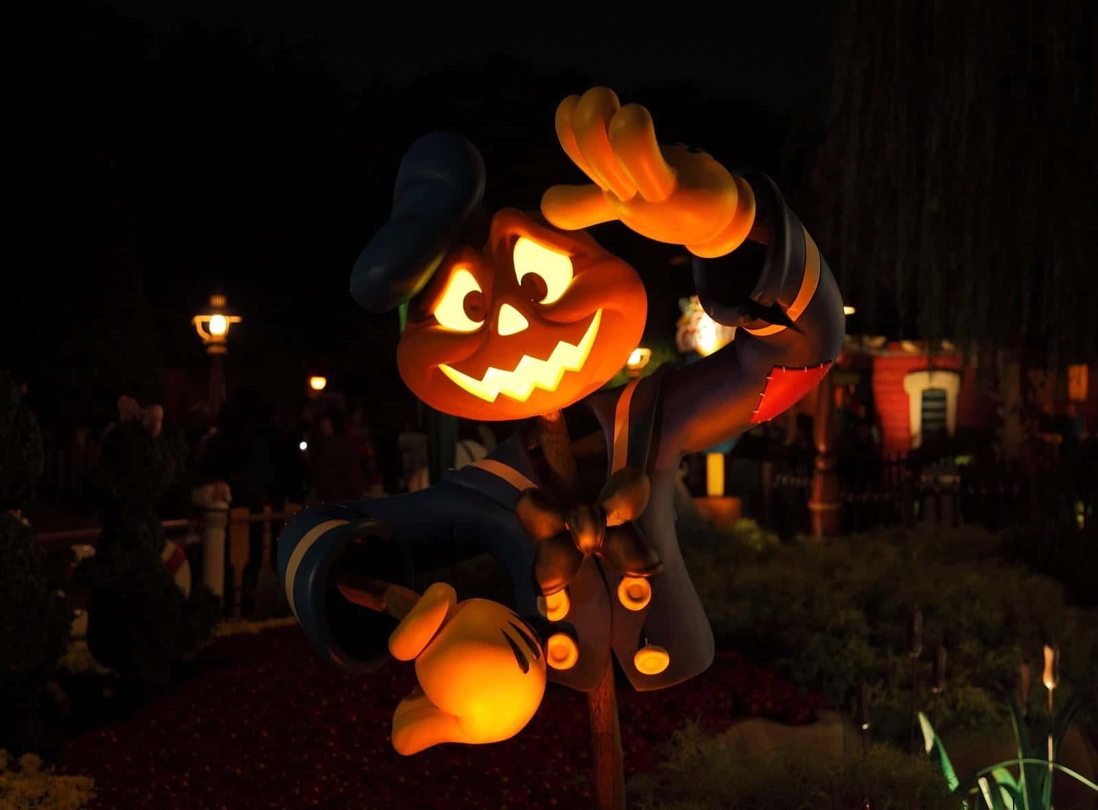 jack-o'-lantern Mickey Mouse statue, festive Halloween park setting, glowing, HD Desktop Wallpaper