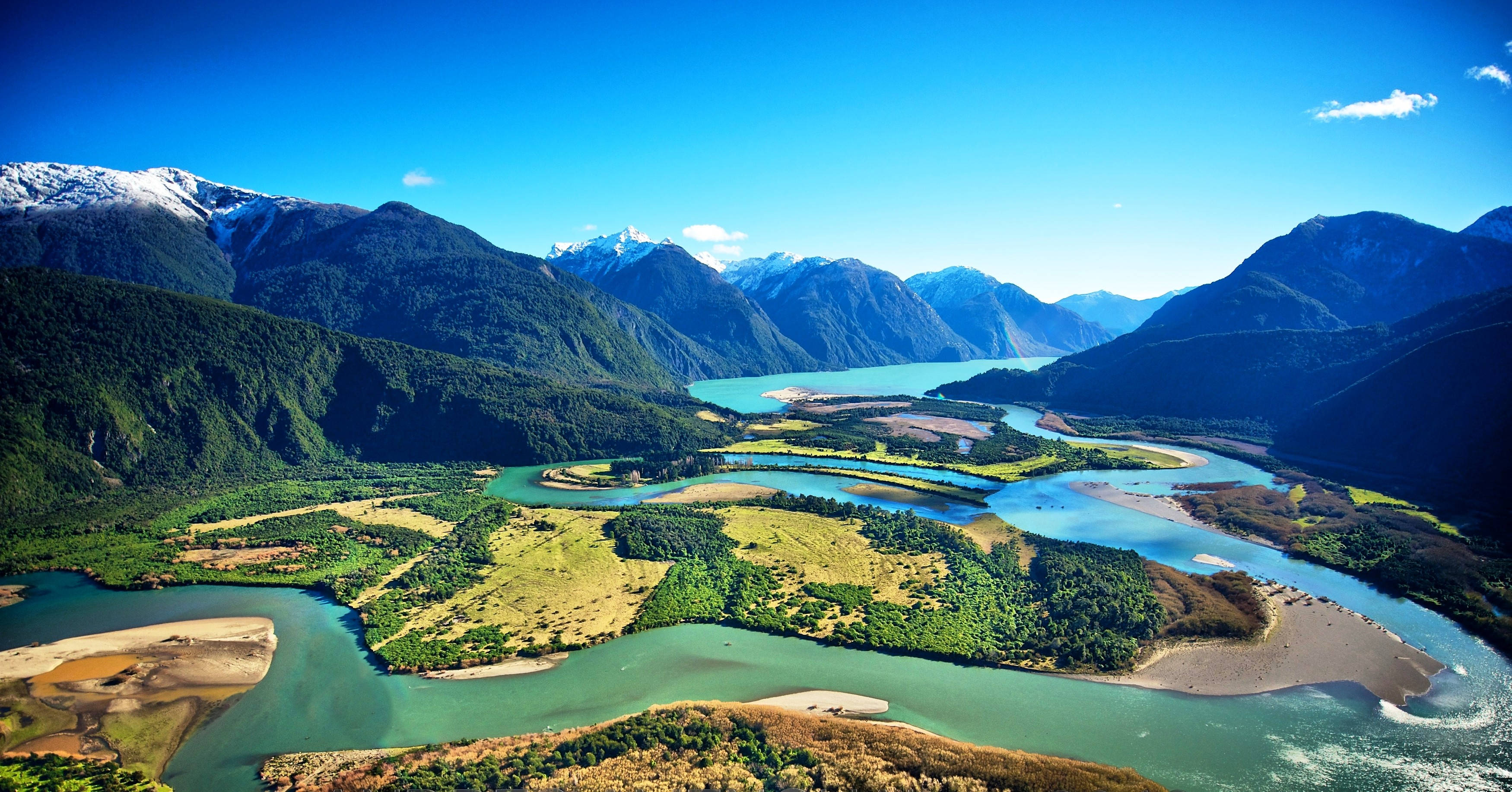 aerial view, winding turquoise river, lush green valleys, 2K Desktop Wallpaper