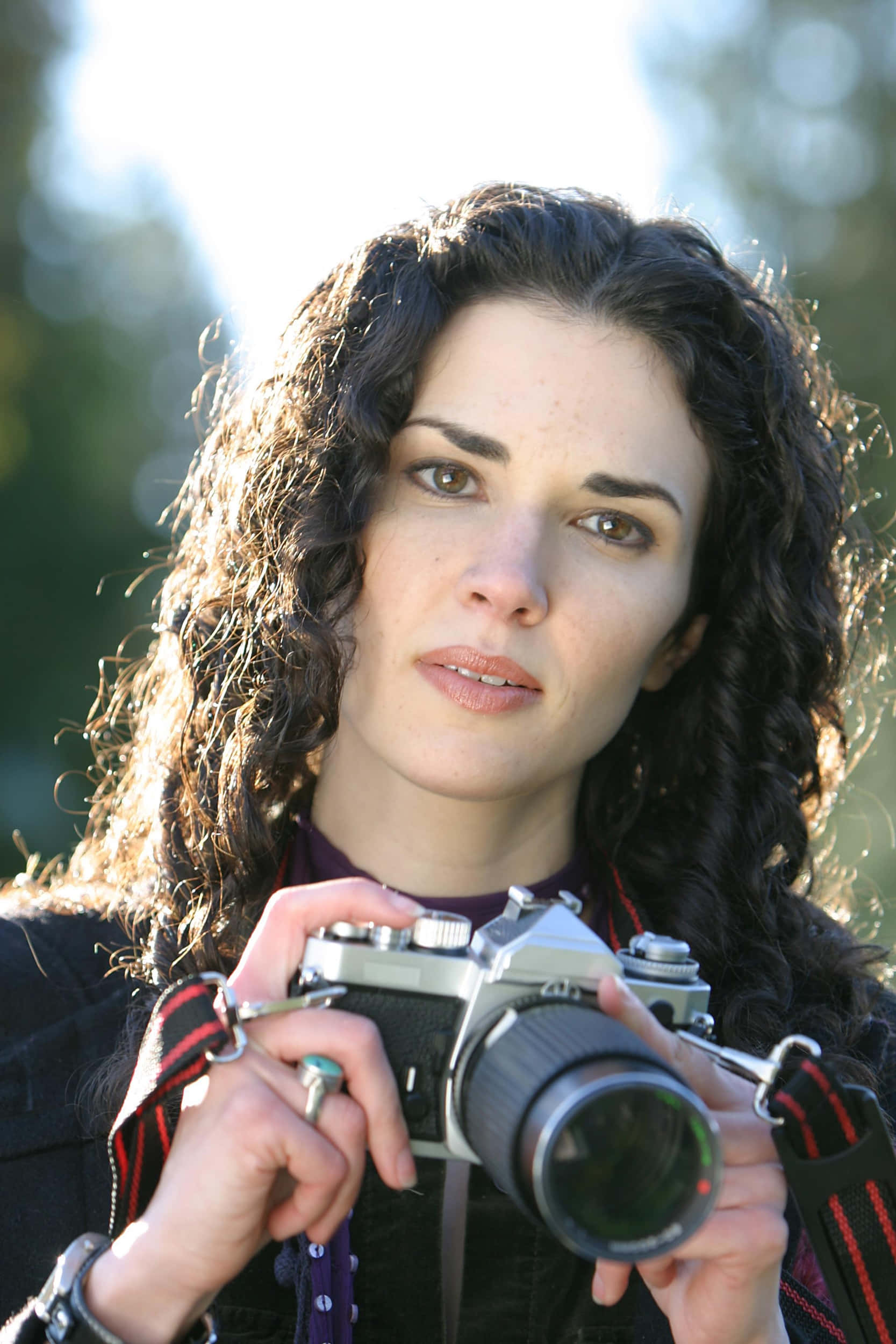 vintage camera, curly dark hair, bright sunlit outdoor backdrop, Full HD Phone Wallpaper