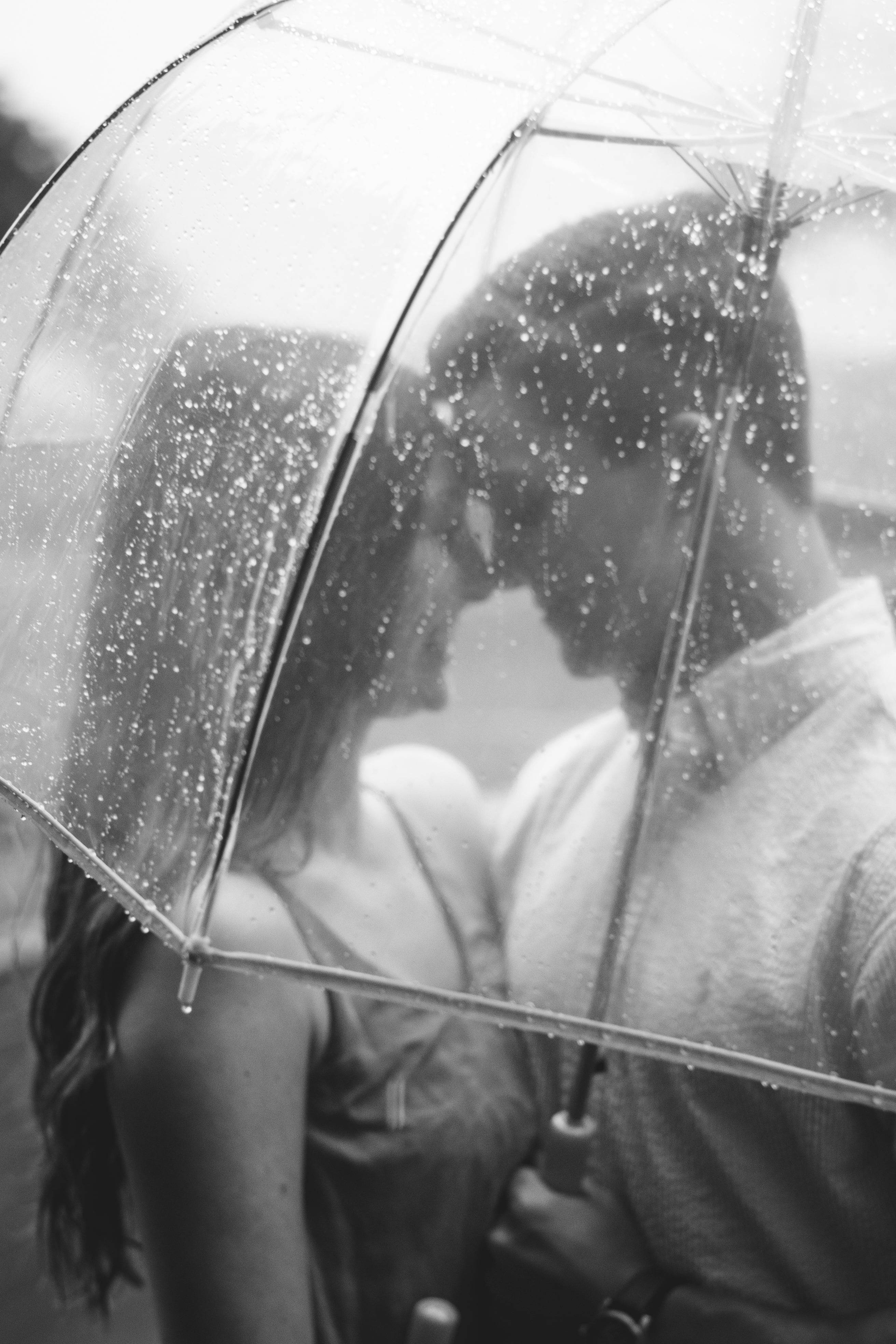 black and white, couple kissing, rain-speckled transparent umbrella, 4K Phone Wallpaper