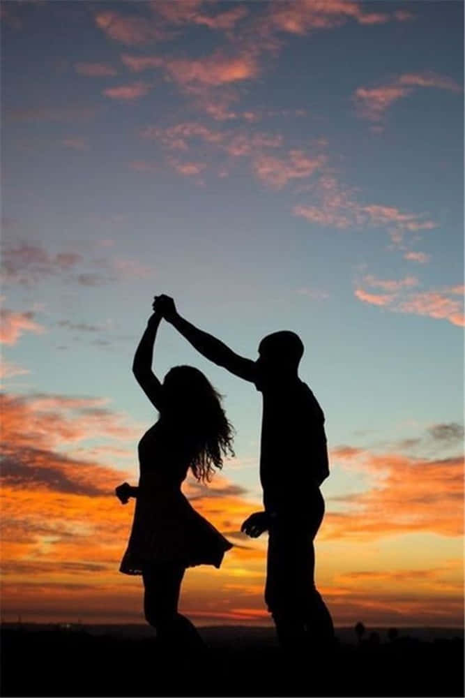 silhouetted couple, vibrant sunset sky, streaks of orange, SD Phone Wallpaper
