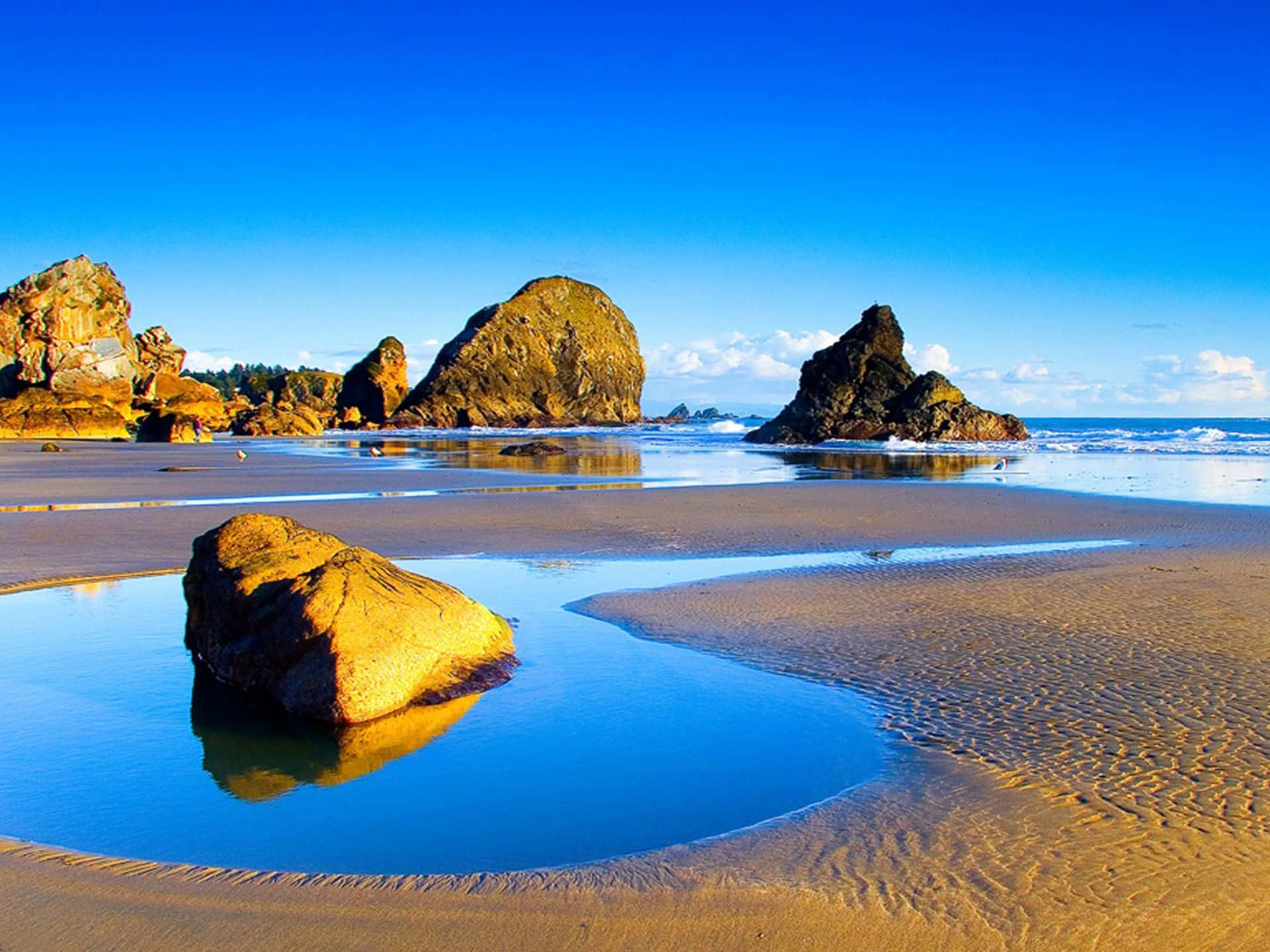 Beautiful Sea, golden sand ripples, large rocks, Full HD Desktop Wallpaper