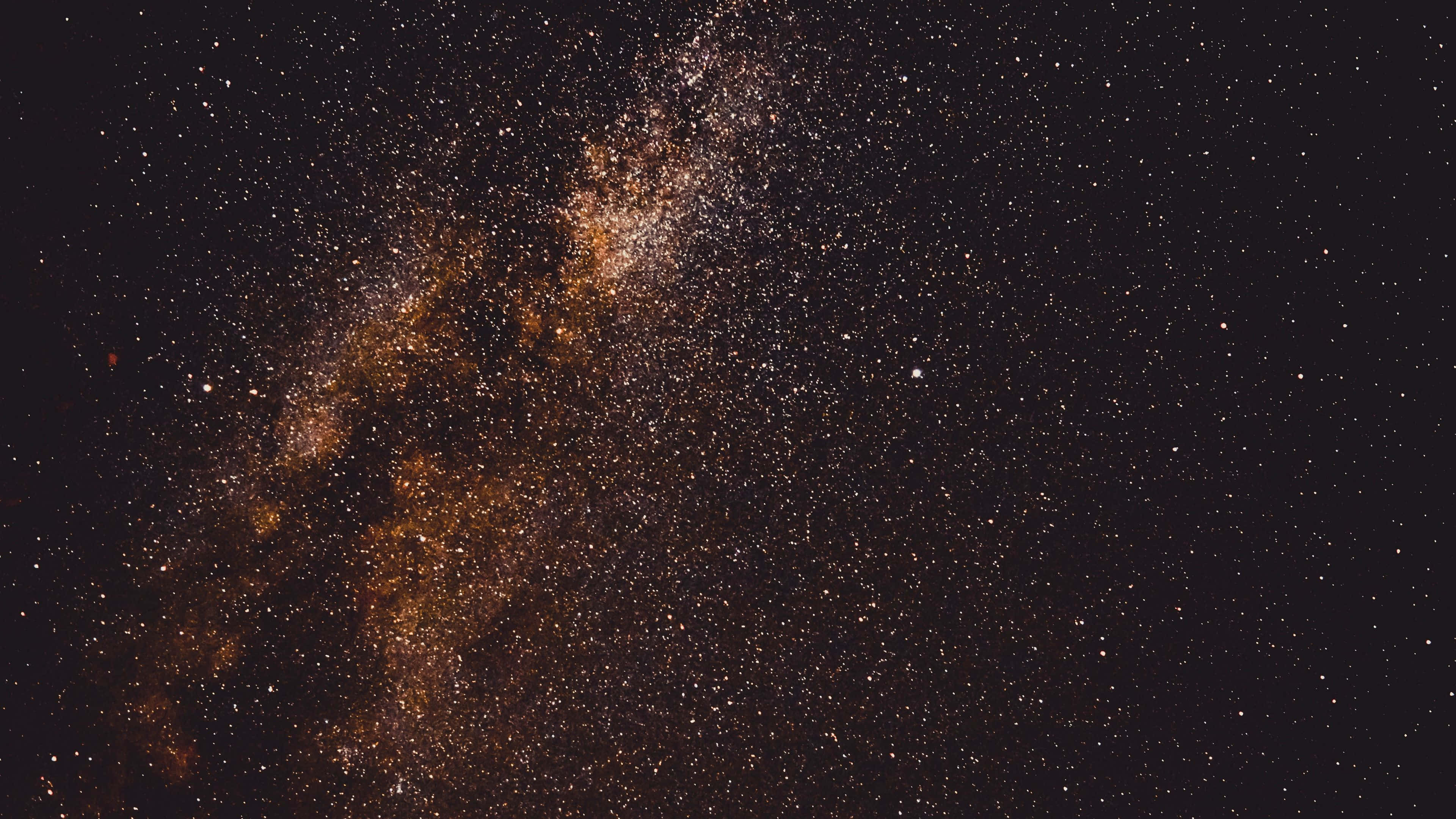 Milky Way galaxy, golden stars, deep black cosmic sky, 4K Desktop Wallpaper