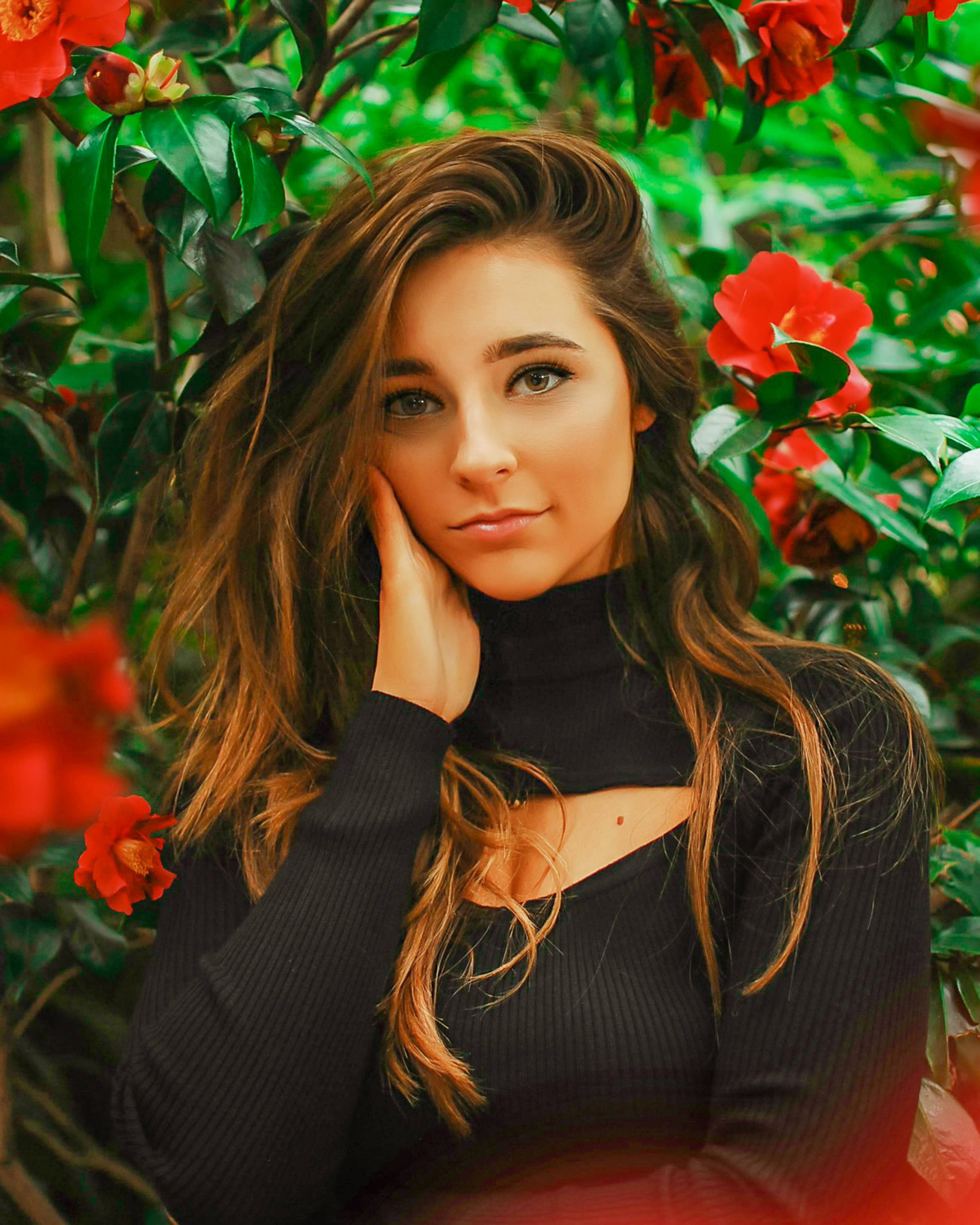 red flowers, wavy brown hair, lush green foliage, 2K Phone Wallpaper