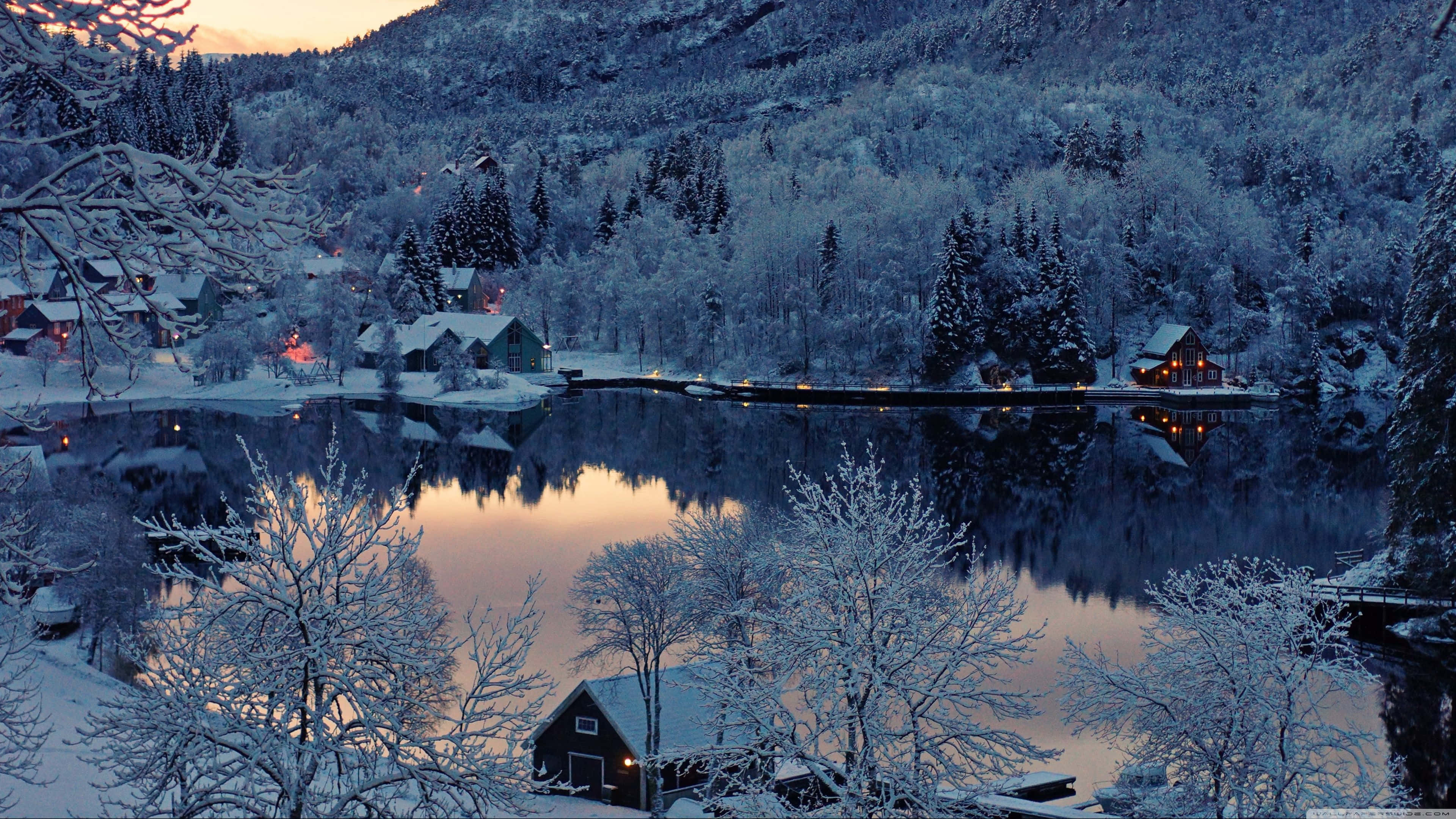 snow-dusted evergreens, frozen lake, snow-covered cabins, 4K Desktop Wallpaper