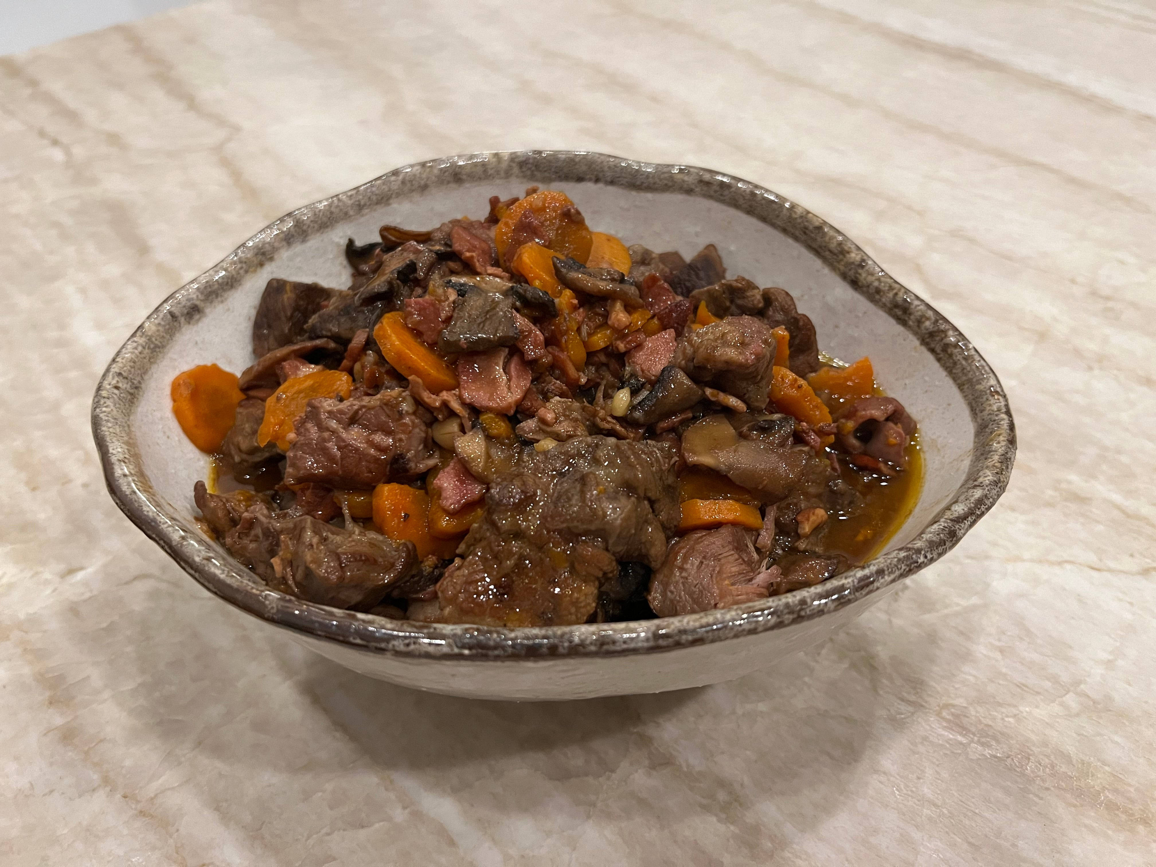 Beef Bourguignon, rustic ceramic bowl, marble countertop, 4K Desktop Wallpaper