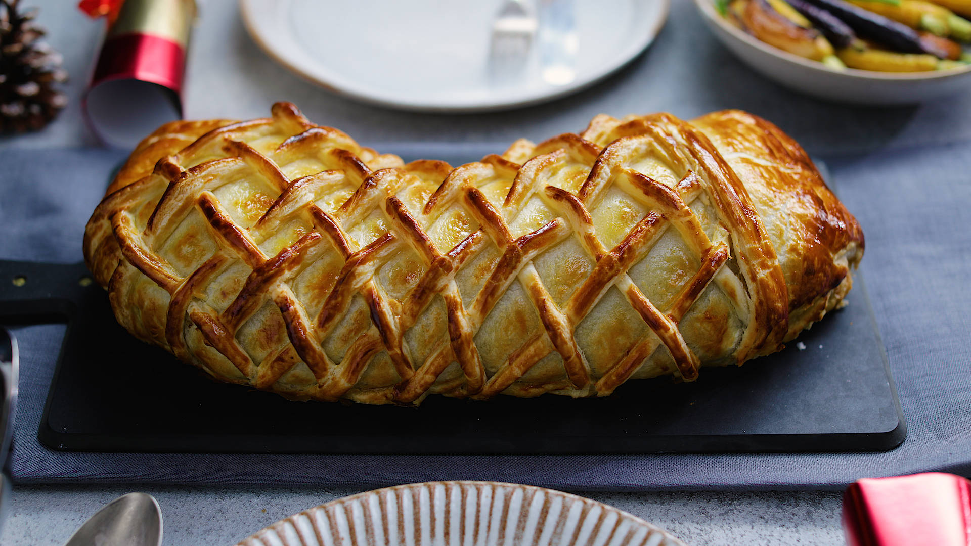 Beef Wellington, golden-brown lattice-topped pastry loaf, dark slate board, Full HD Desktop Wallpaper