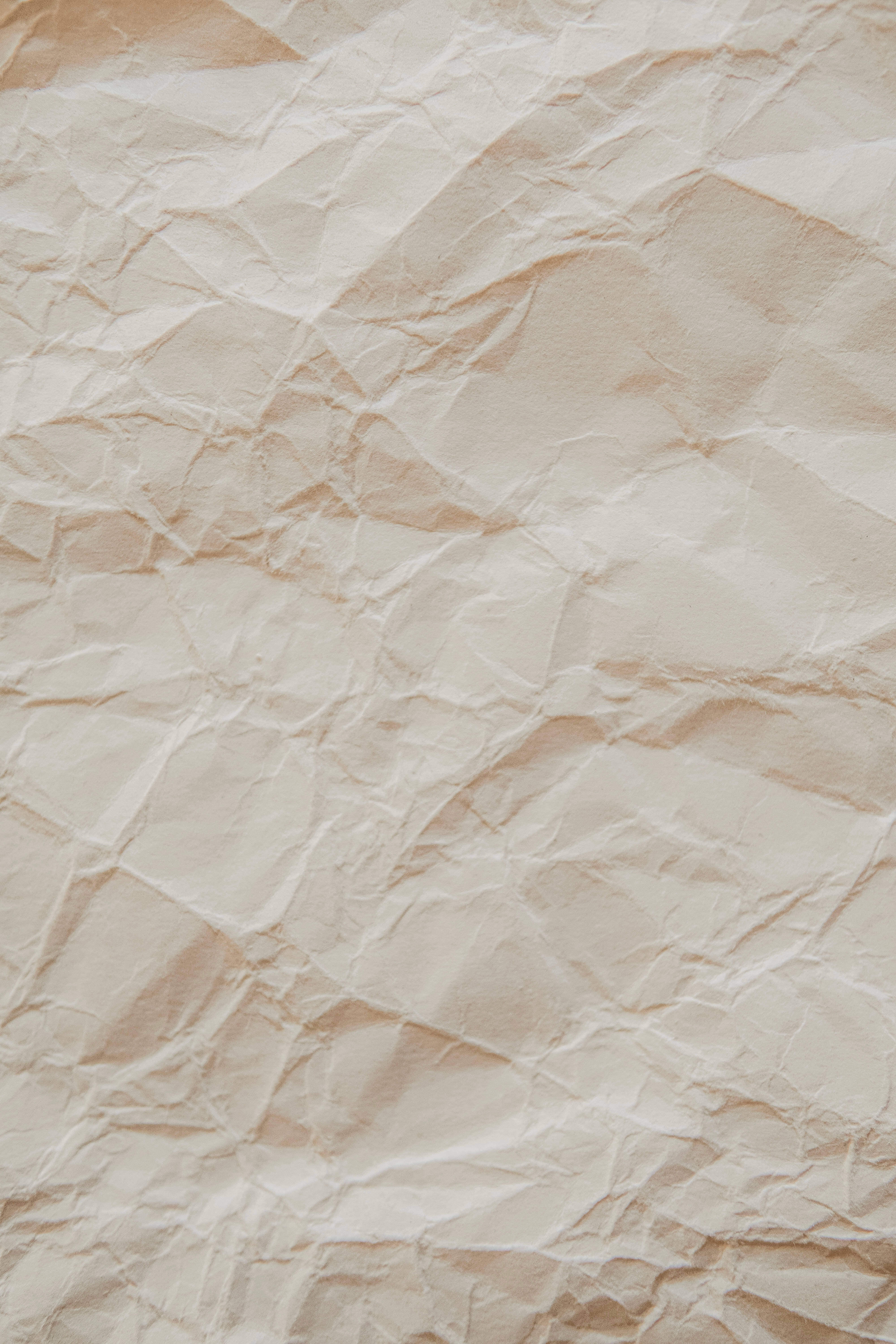 soft beige crumpled paper, textured beige, soft shadows, 5K Phone Wallpaper
