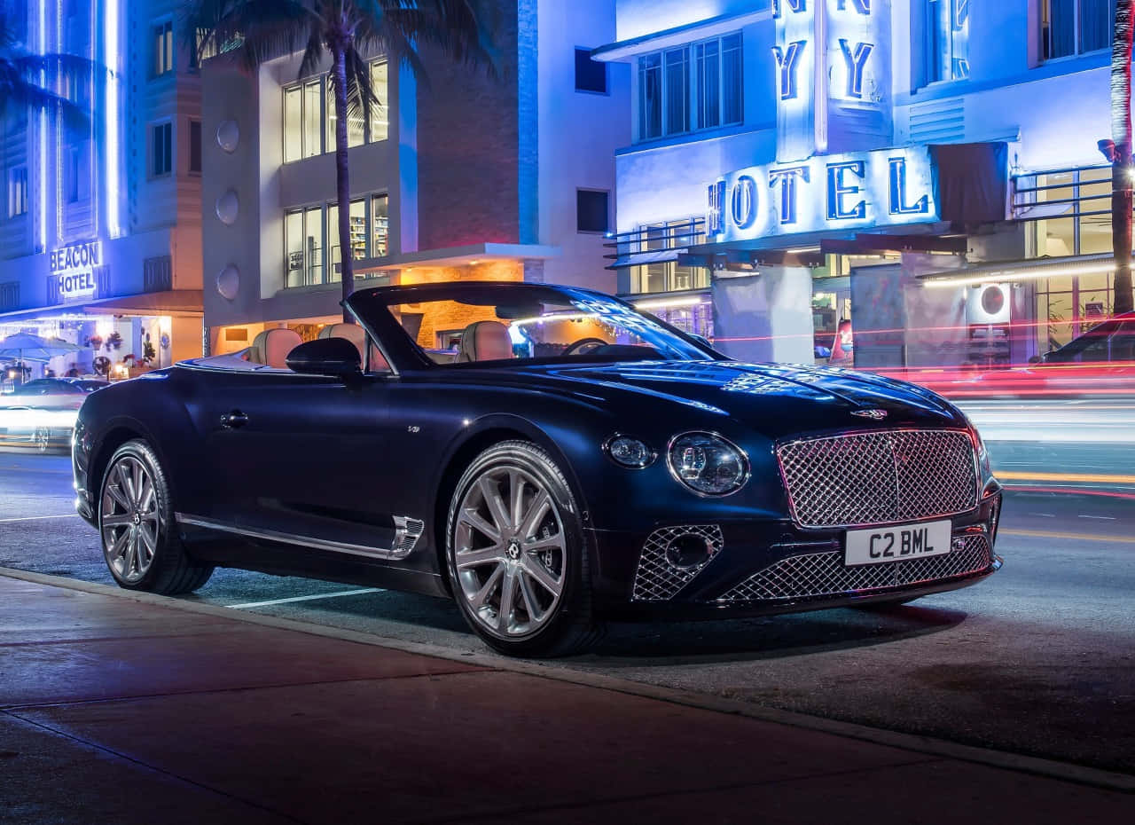 Bentley Continental GT Convertible, neon-lit Art Deco hotel, palm trees, HD Desktop Wallpaper