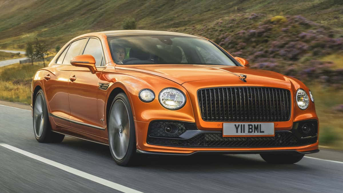 Bentley Flying Spur, vibrant orange, winding mountain road, SD Desktop Wallpaper