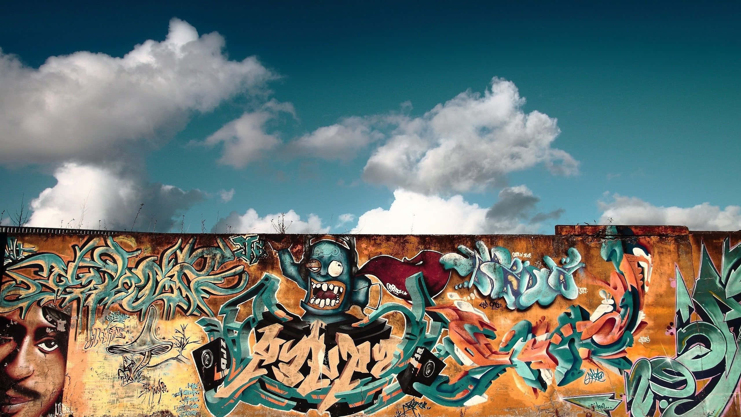 Berlin Wall, colorful graffiti mural, blue skies, 2K Desktop Wallpaper