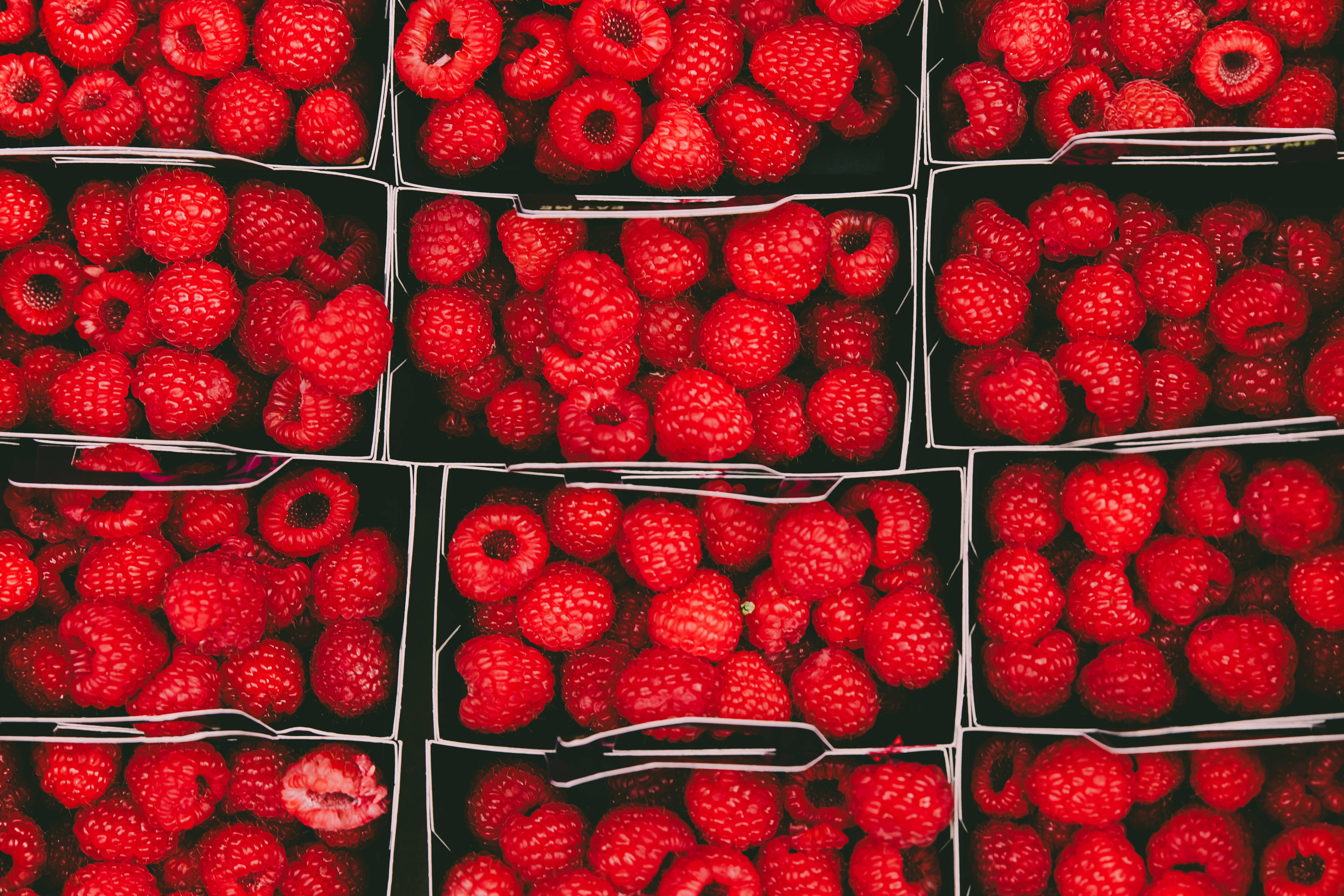 red raspberries, black trays, top-down market display, 5K Desktop Wallpaper