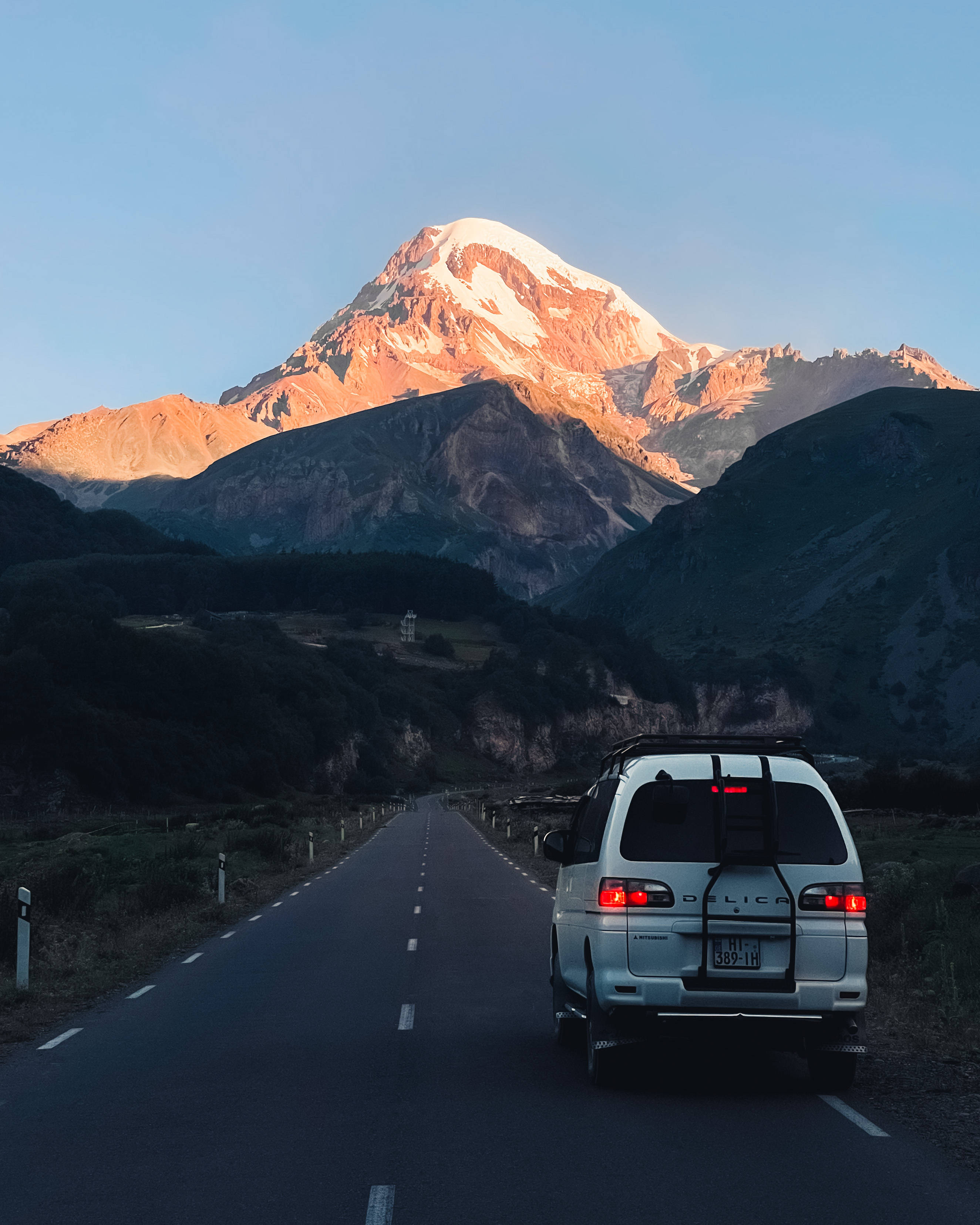 snow-capped peak, golden sunset light, mountain road, 2K Phone Wallpaper