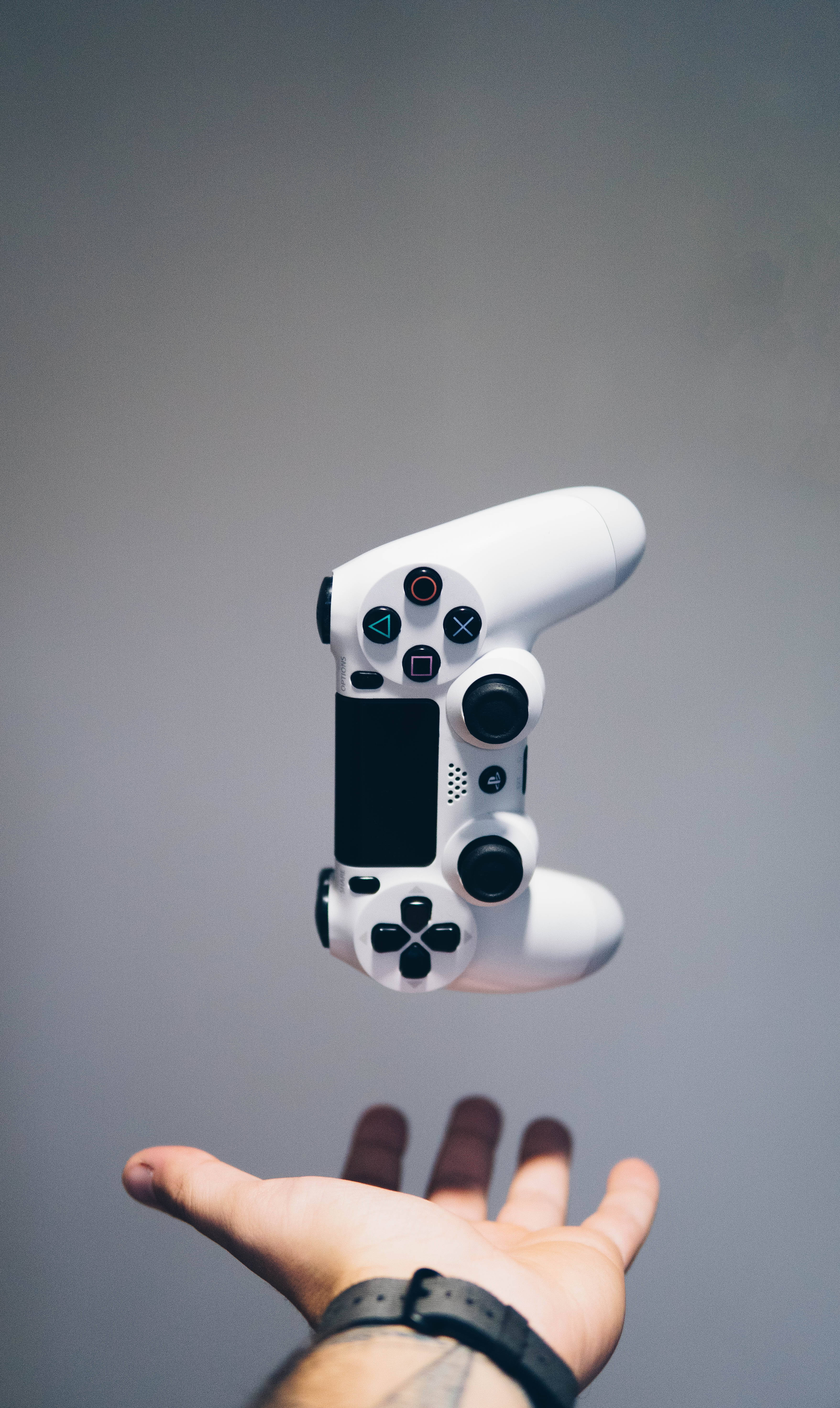 PS4, white PlayStation controller, outstretched hand, 5K Phone Wallpaper