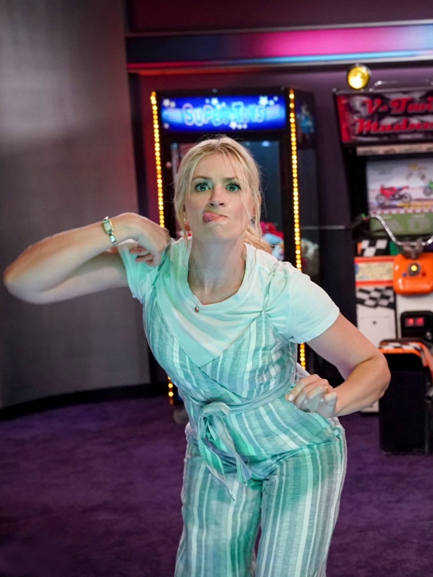 Beth Behrs, teal striped outfit, neon-lit arcade, Full HD Phone Wallpaper
