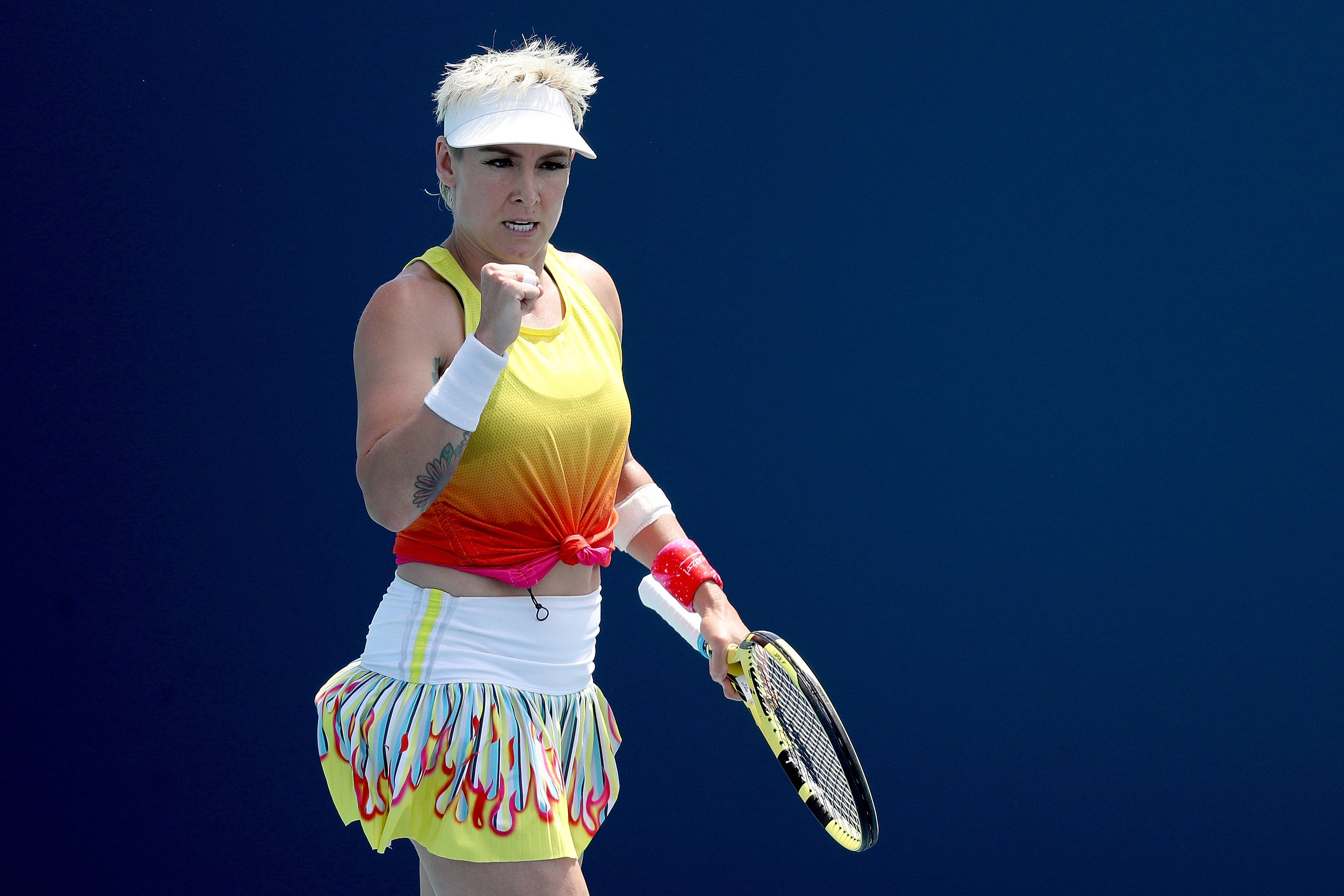 Bethanie Mattek-sands, vibrant yellow and orange outfit, solid blue background, 2K Desktop Wallpaper