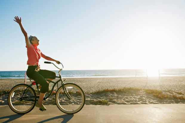 freedom in bike ride, sunlit beach, joyful woman, SD Desktop Wallpaper