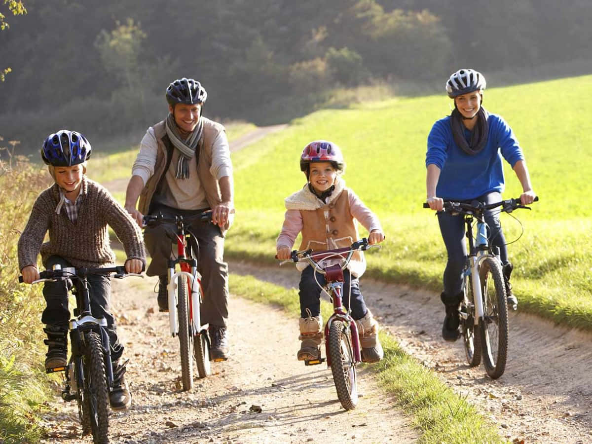 family of four, bicycles, sunlit dirt path, SD Desktop Wallpaper