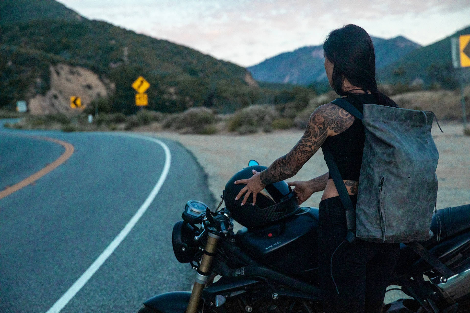 tattooed woman, motorcycle helmet, winding mountain road, Full HD Desktop Wallpaper