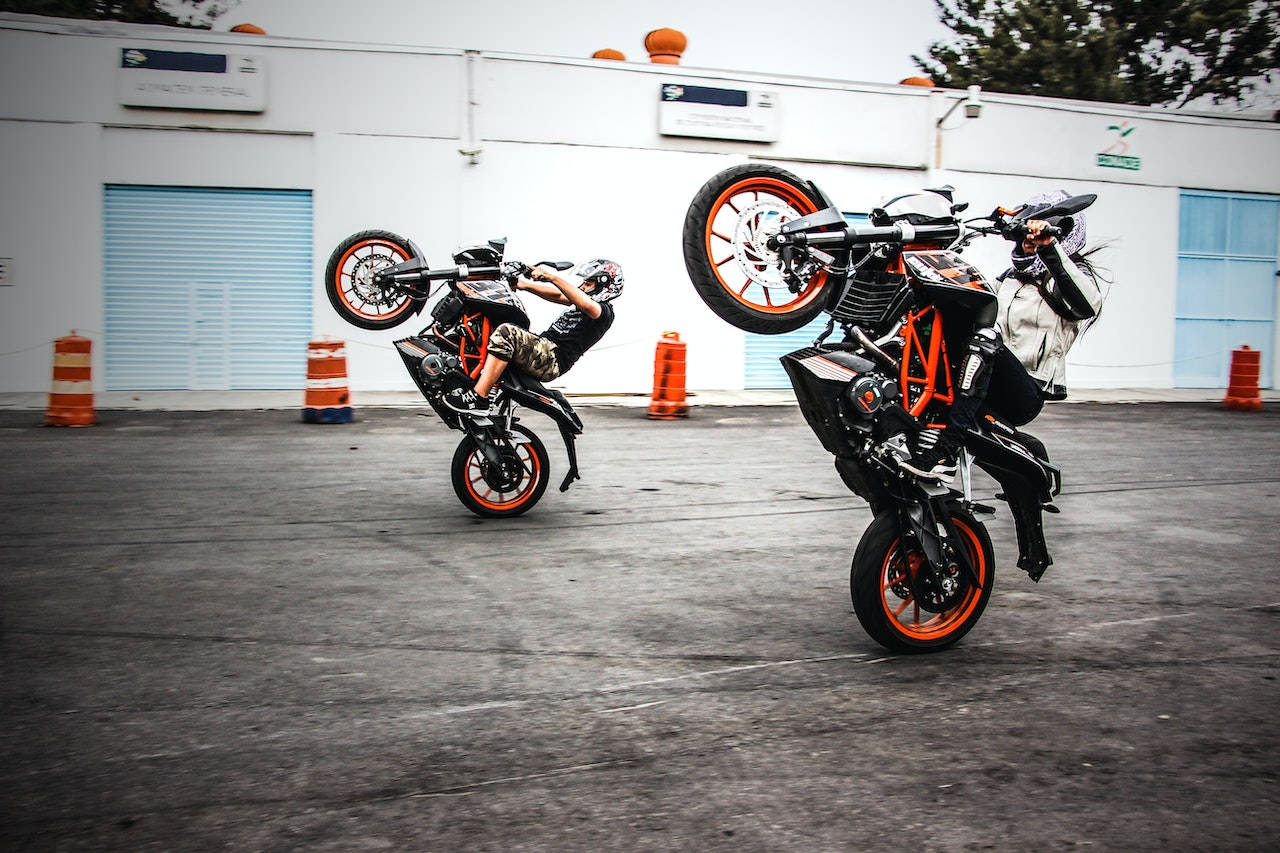 wheelies, orange and black bikes, industrial parking lot, HD Desktop Wallpaper