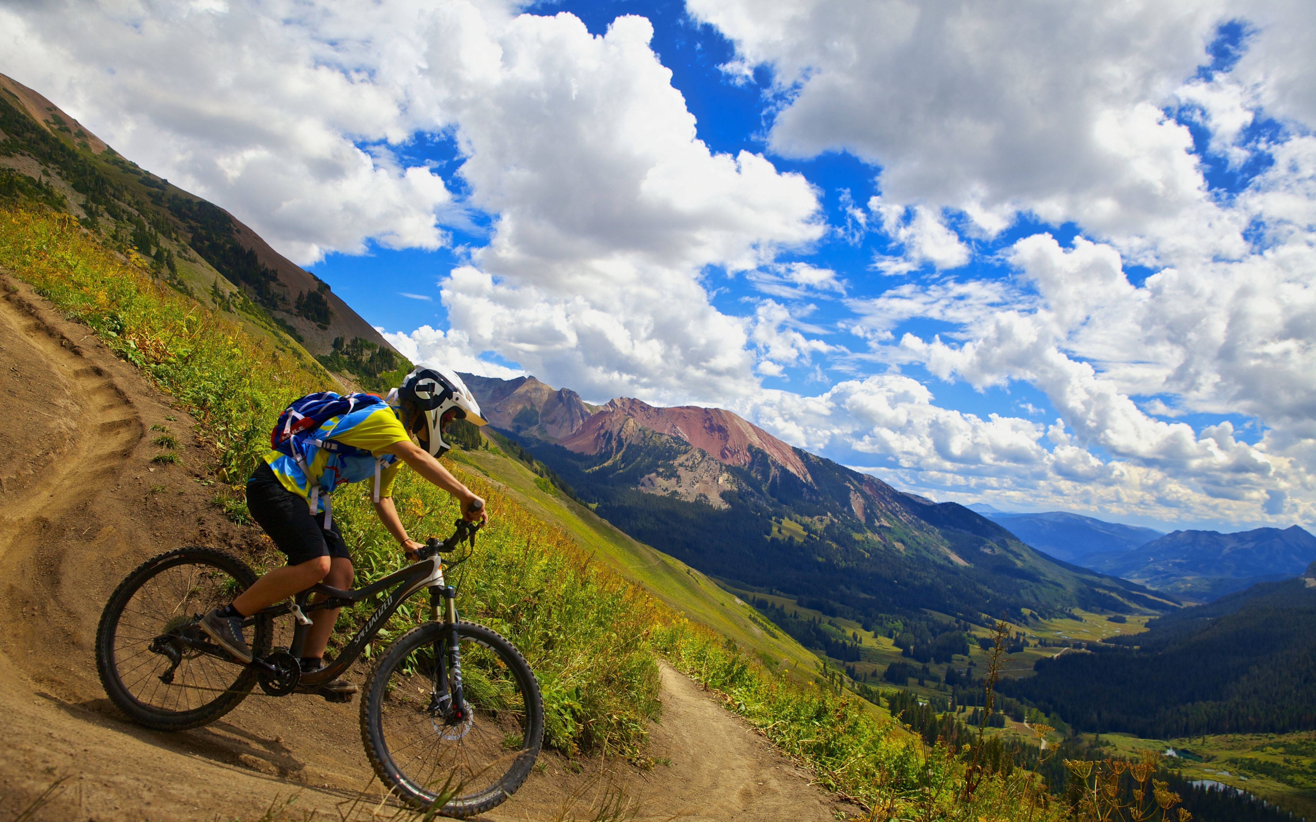 mountain biker, dirt trail, dramatic clouds, 5K Desktop Wallpaper