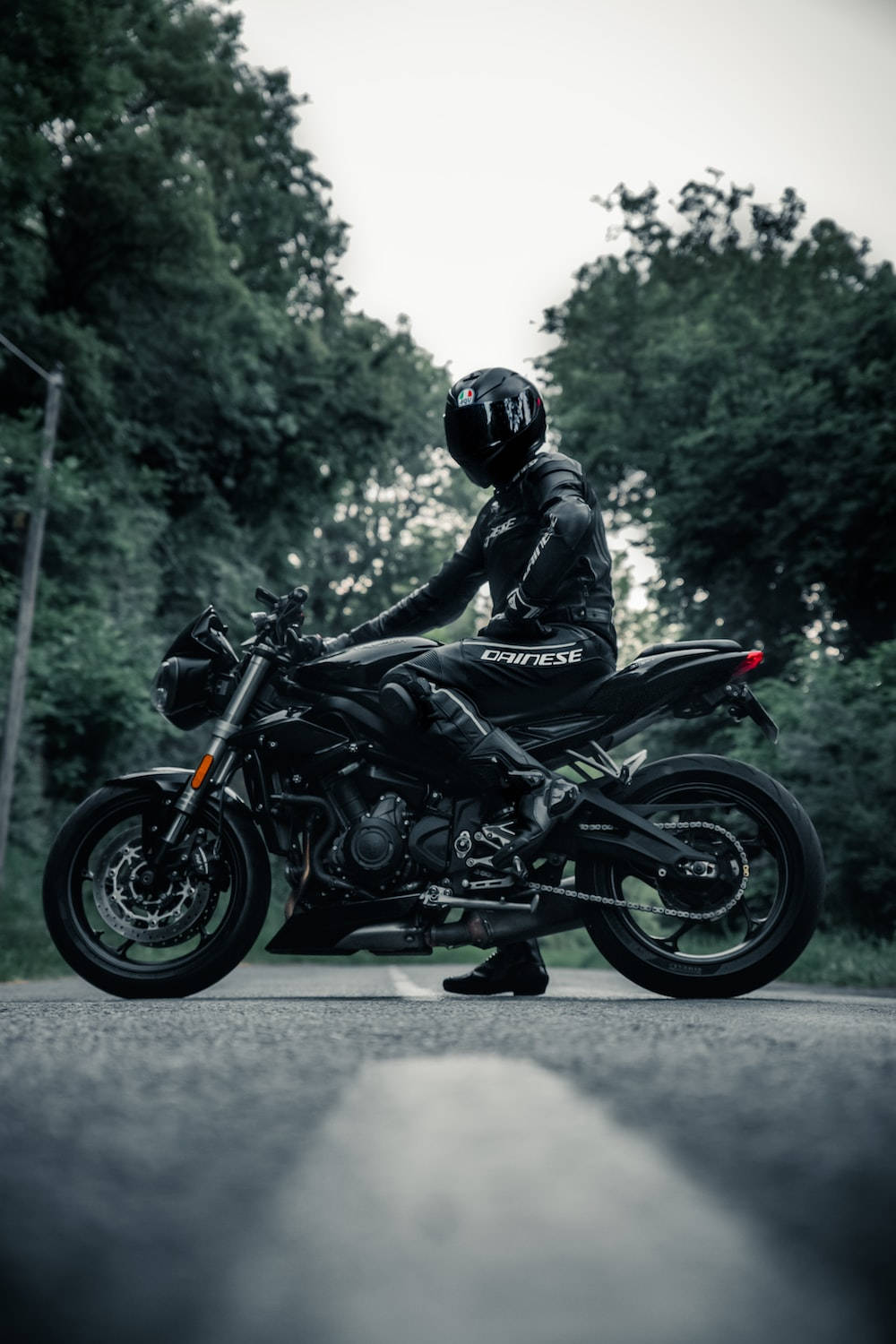 black motorcycle, full black gear, tree-lined road, HD Phone Wallpaper