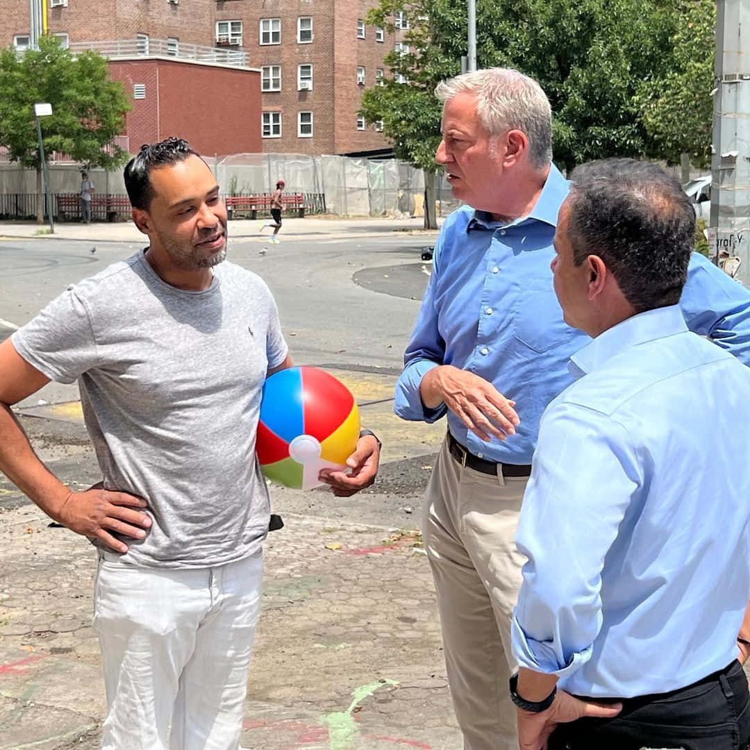 Bill De Blasio, sunlit urban courtyard, colorful beach ball, SD Desktop Wallpaper