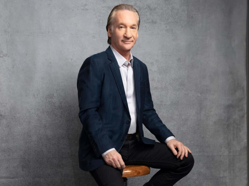 Bill Maher, navy blazer, wooden stool, SD Desktop Wallpaper