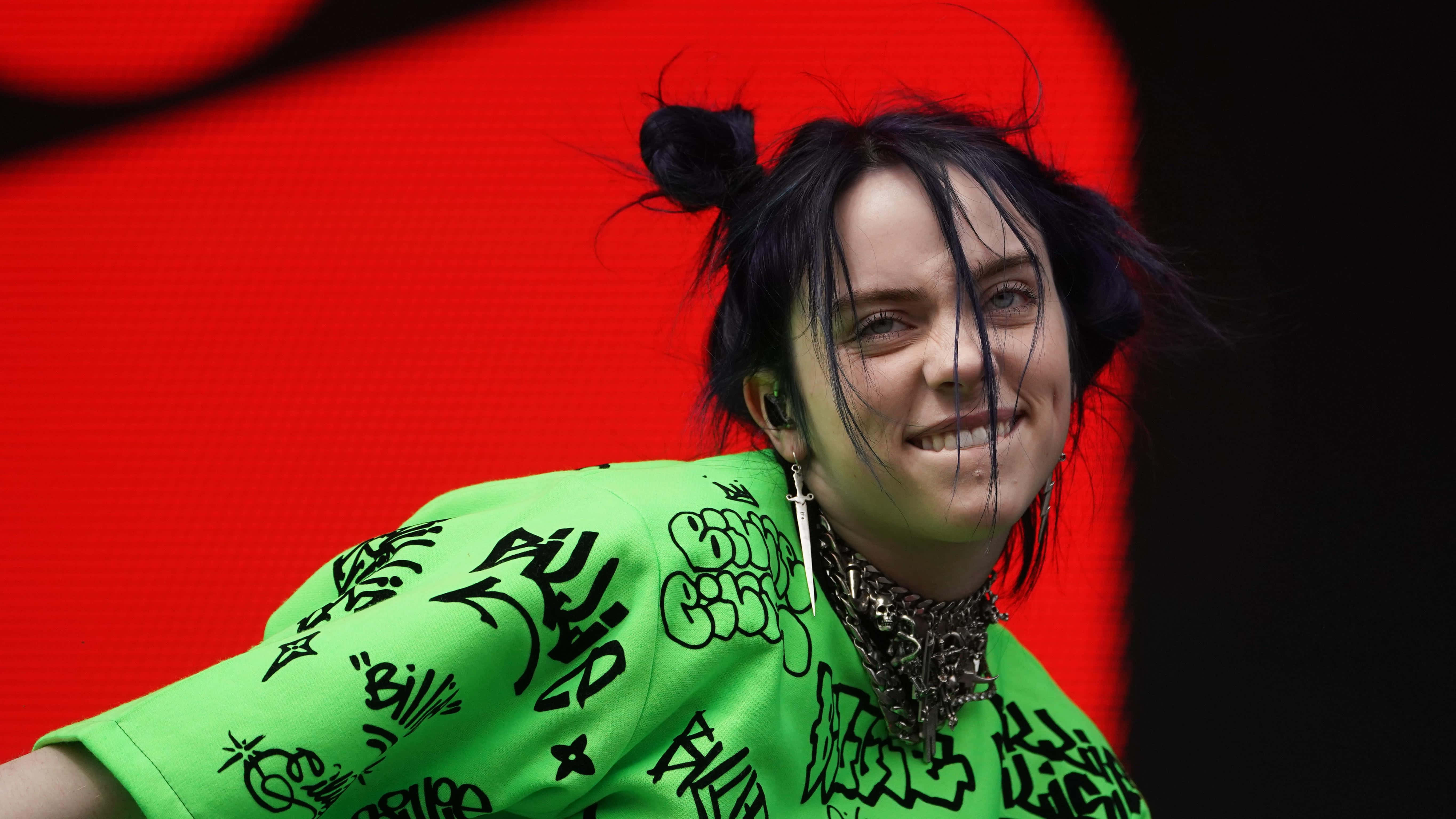 Billie Eilish, neon green graffiti shirt, vivid red background, 5K Desktop Wallpaper