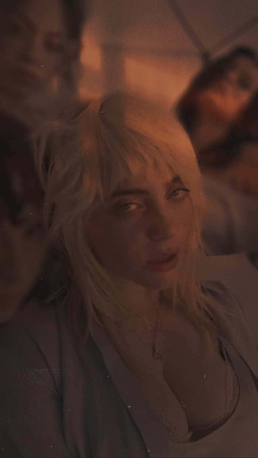 Billie Eilish, tousled blonde hair, dim warmly lit room, HD Phone Wallpaper
