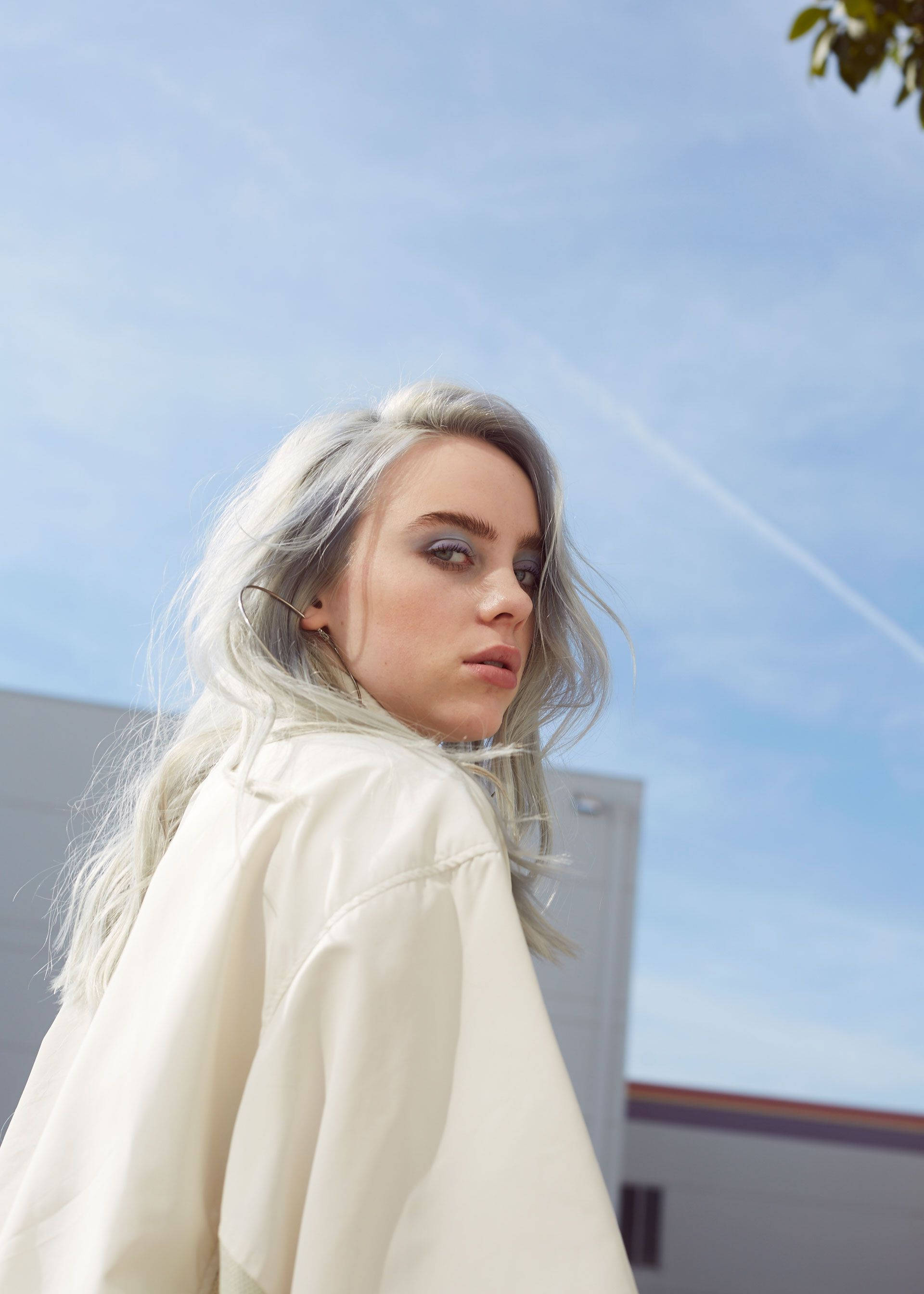 Billie Eilish, yellow shirt, bright blue sky, 2K Phone Wallpaper