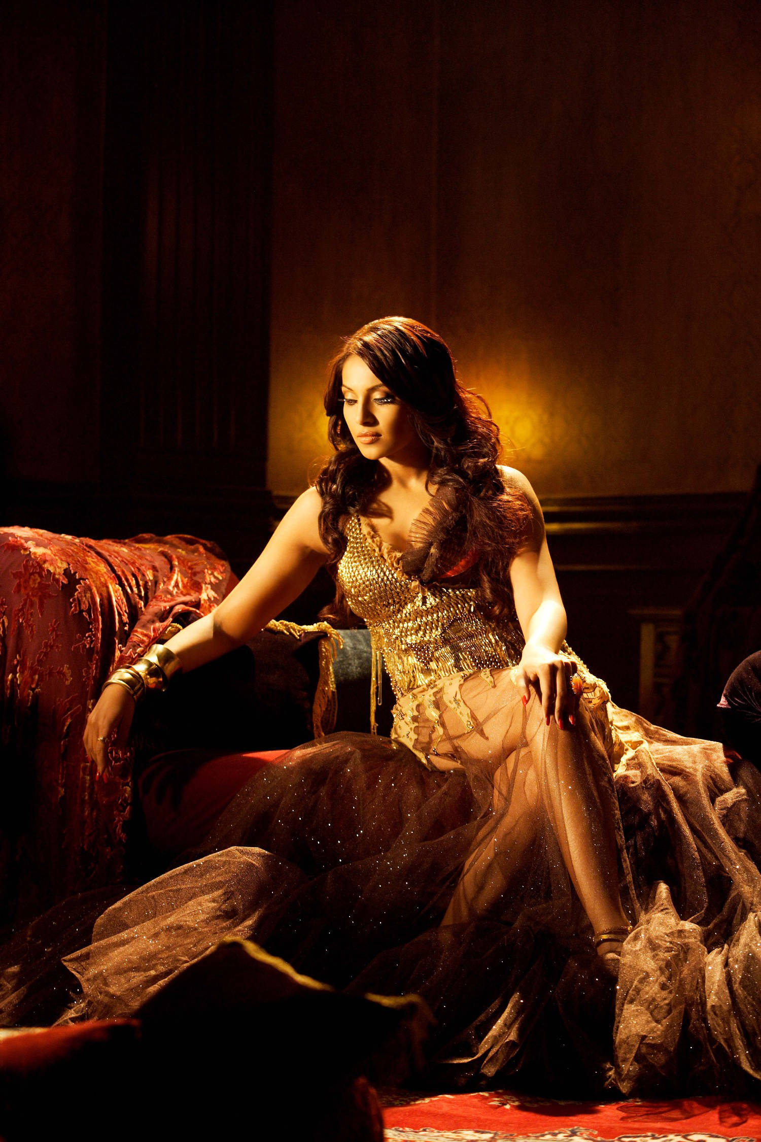 Bipasha Basu, shimmering gold and black gown, red velvet couch, Full HD Phone Wallpaper