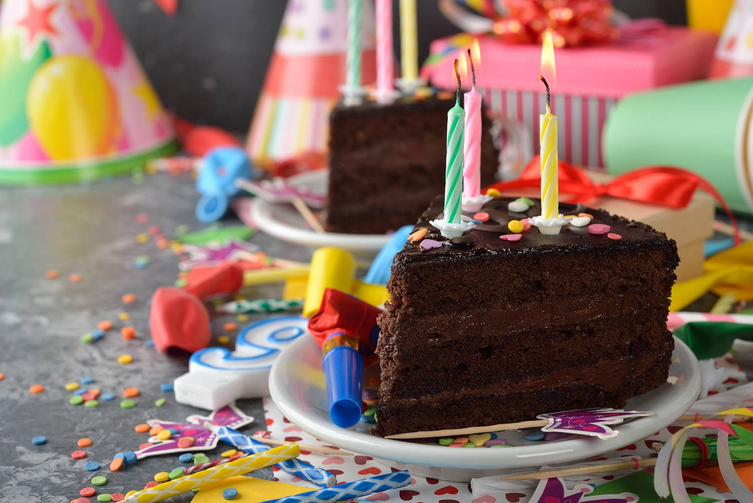 slice chocolate birthday cake, lit candles, colorful party hats, HD Desktop Wallpaper