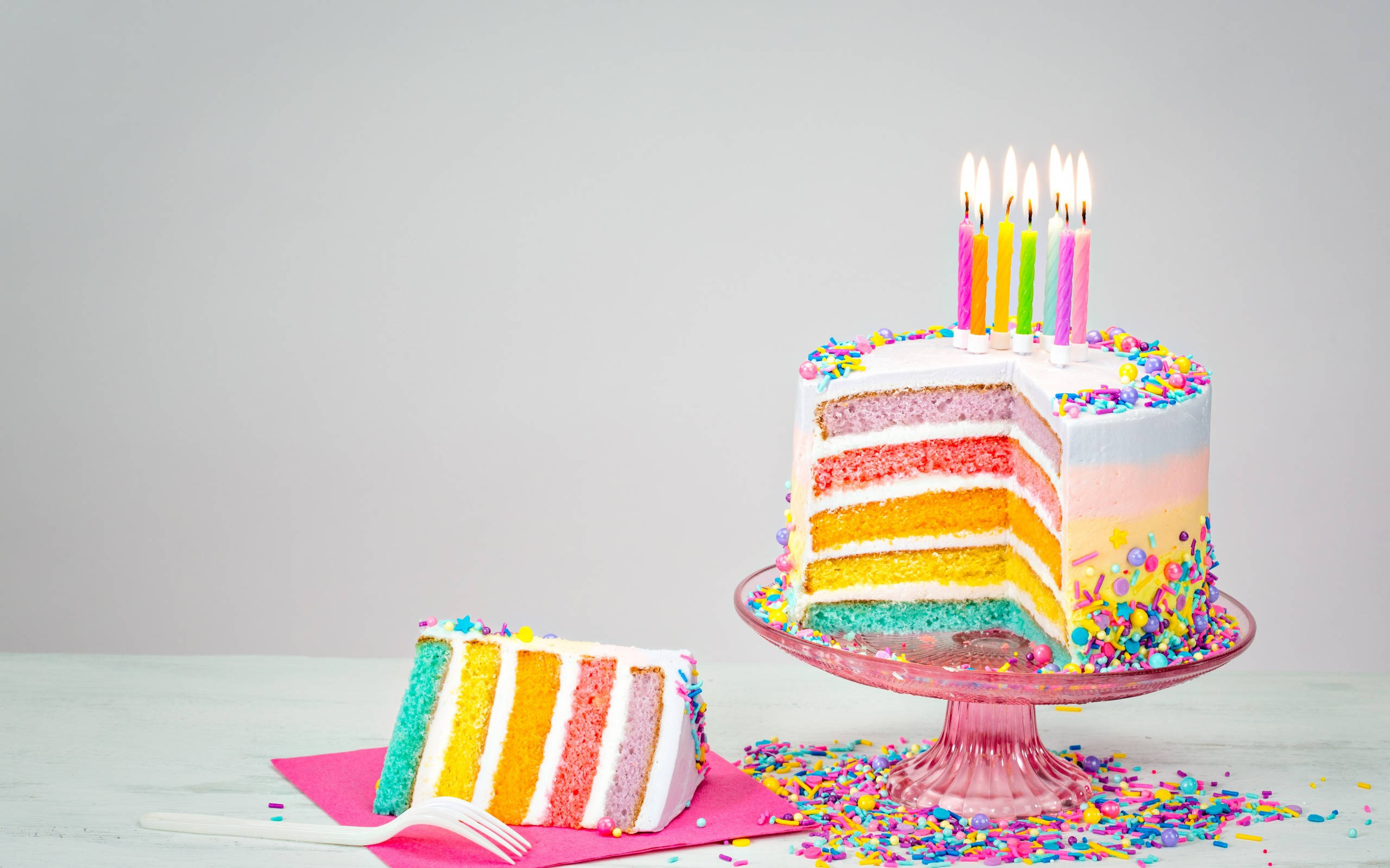 pastel layer birthday cake candles, rainbow-layered birthday cake, lit candles, 2K Desktop Wallpaper