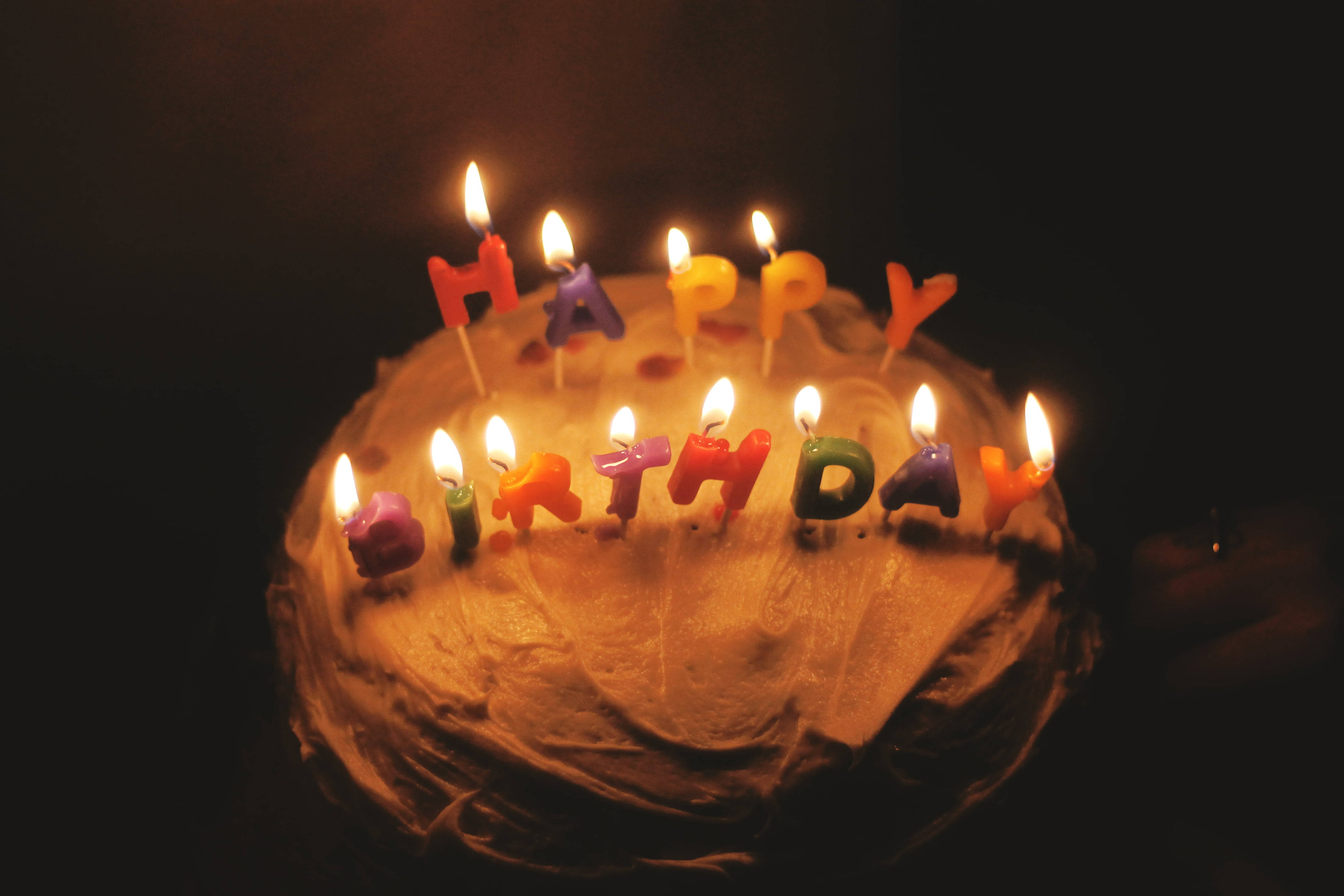 birthday cake, lit colorful candles, dark background, 4K Desktop Wallpaper