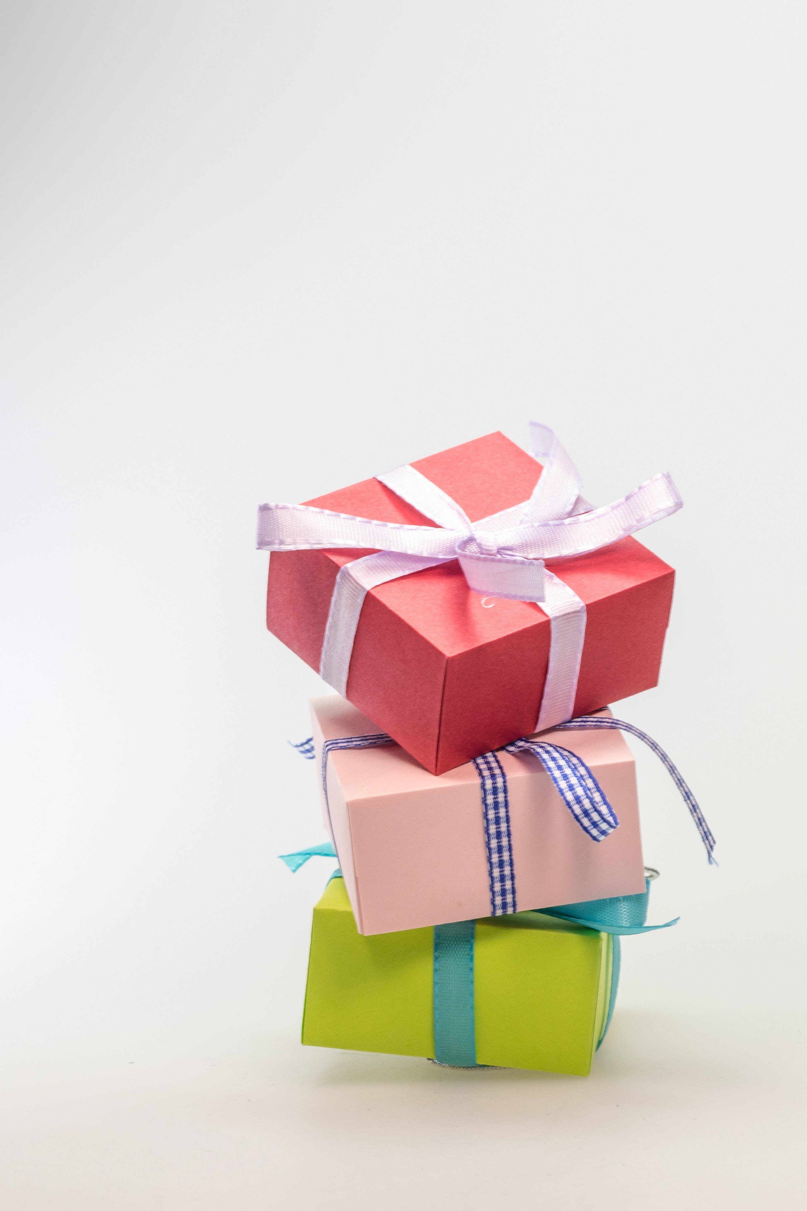 birthday, stacked colorful gift boxes, plain white background, 4K Phone Wallpaper